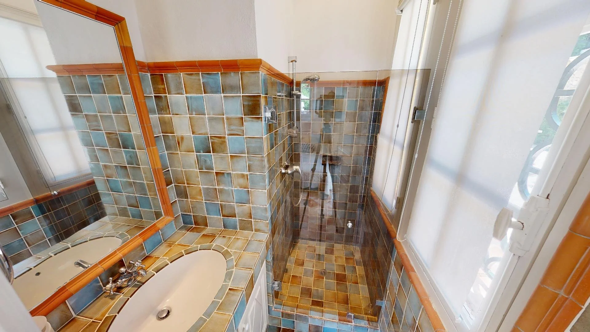 Modern bathroom with glass shower at Saint-Tropez villa rental.