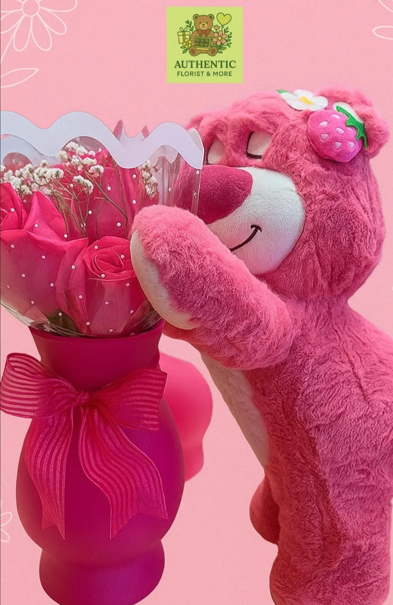 A pink teddy bear holding a bouquet of pink flowers, all set against a pink background with white flower illustrations. The teddy bear has a strawberry and a white flower decoration on its head. There is also a green logo with a bear, flowers, and a gift box that reads 'Authentic Florist & More'.