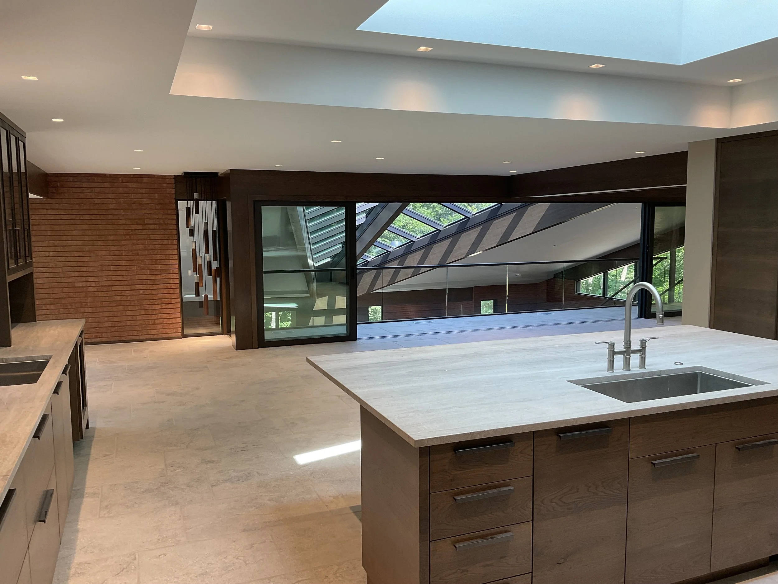 A custom mid-century modern renovation anchored by a floating architectural skylight. Warm wood tones, refined materials, and precise detailing bring clarity and balance to the space while respecting the home’s original character.