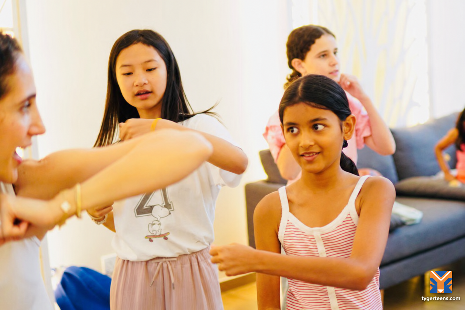 Students practise controlled movements together in a guided fitness session.