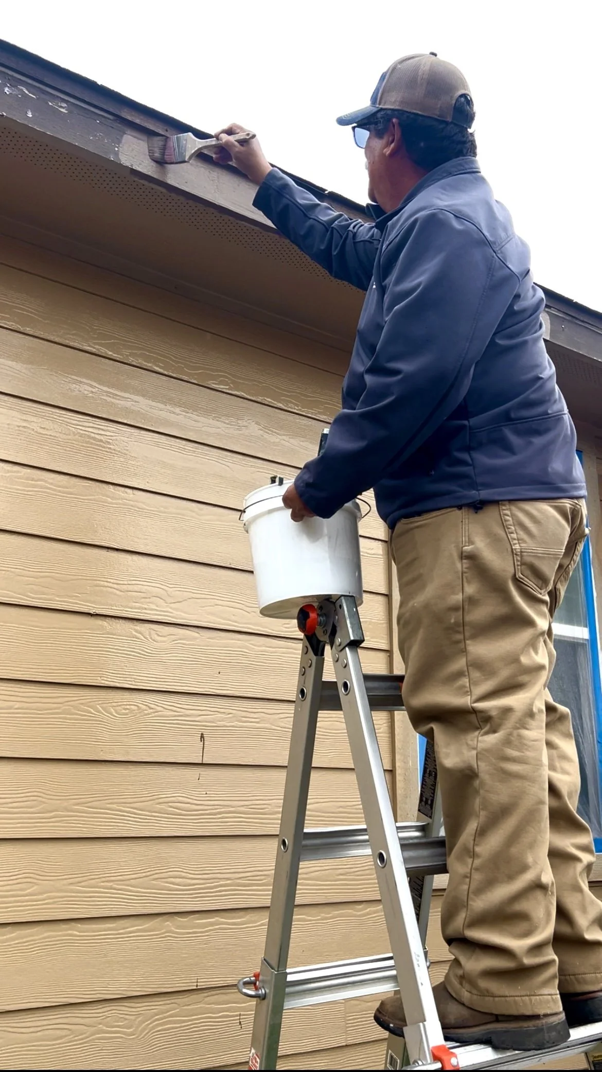 Professional painter painting the exterior of a home in San Antonio