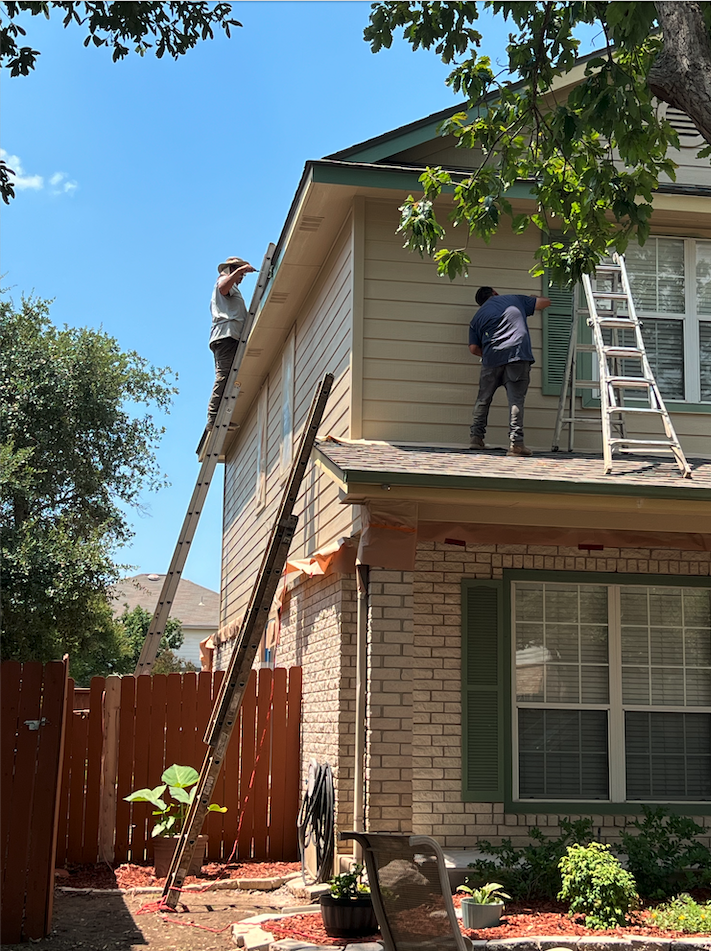 Brush Paint Pros painting a two-story home exterior in San Antonio