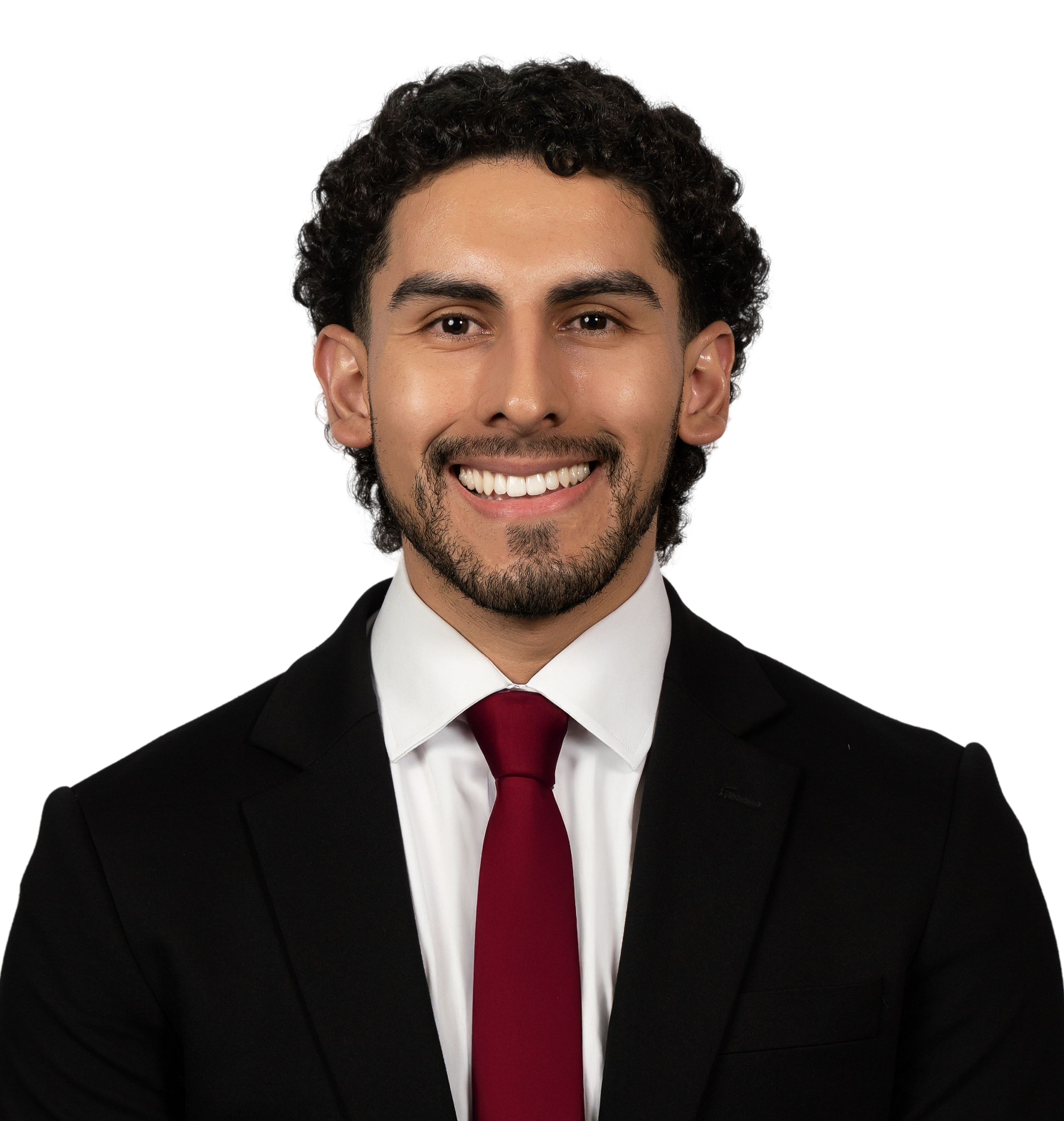 Headshot of a smiling young man in a suit and red tie against a white background.
