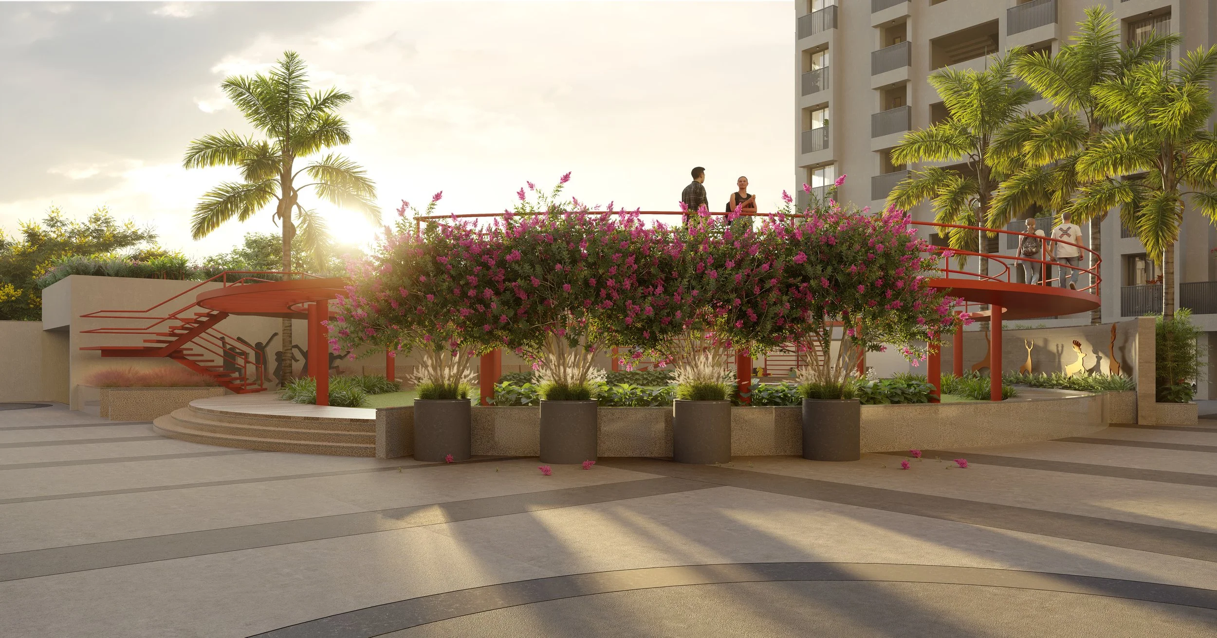 An outdoor courtyard with a red spiral staircase, pink flowering trees, palm trees, and people walking and talking, with a tall building in the background.