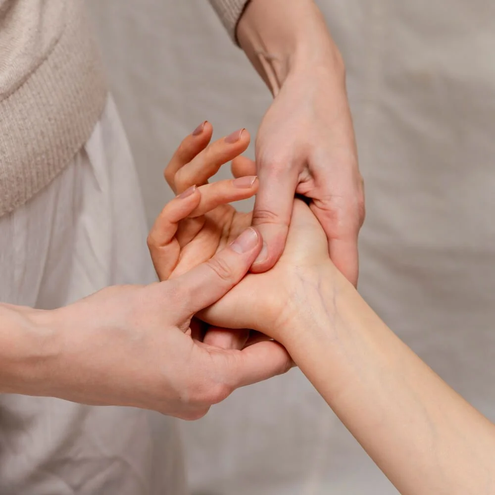 Relaxing reflexology being performed on a womans hands