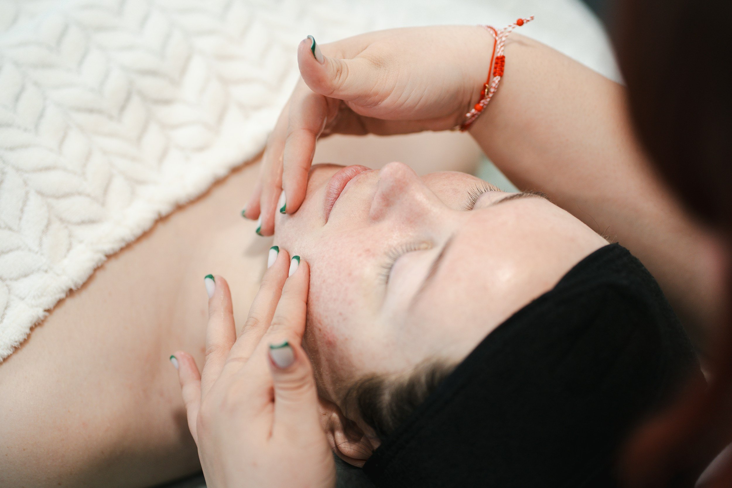 Hands performing Access Bars treatment as part of a professional holistic therapy session in Cumbria