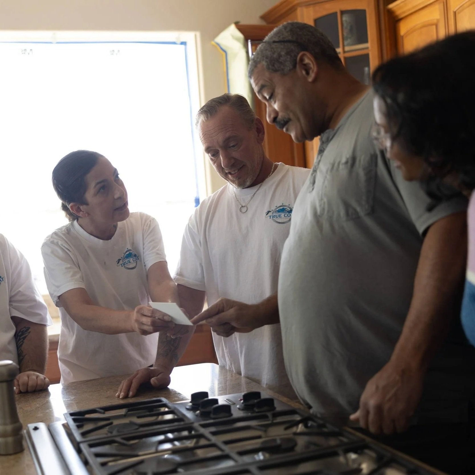 Commercial property manager reviewing a power washing proposal with contractors during an on-site building inspection to assess exterior cleaning needs and maintenance costs.