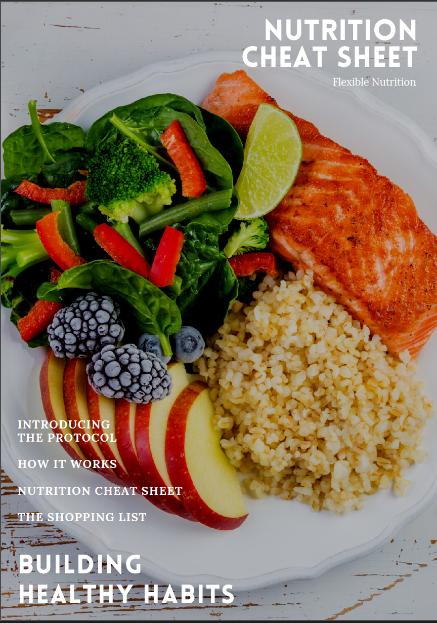 A white plate with a cooked salmon fillet, a lemon wedge, a mound of cooked couscous, a fresh green salad with cherry tomatoes, broccoli, spinach, blueberries, blackberries, and apple slices, on a rustic wooden surface.
