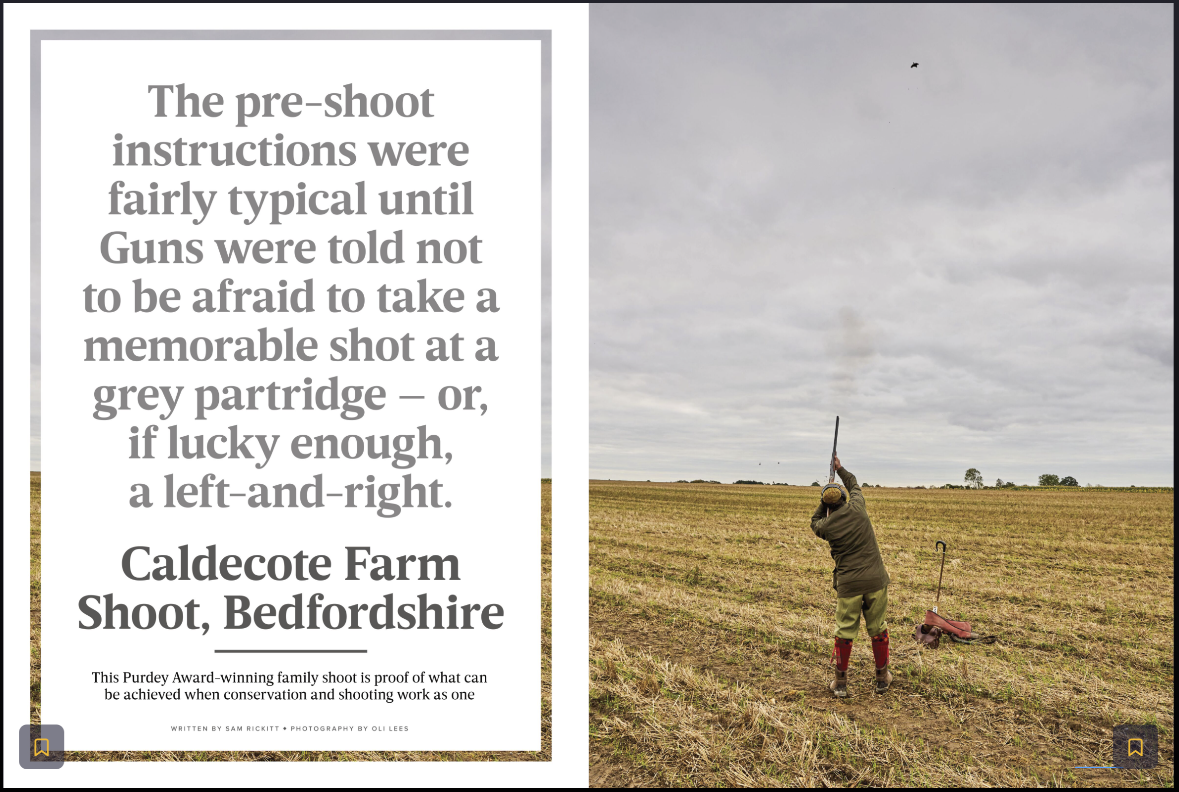 Farmer in a field shooting a shotgun into the sky on a cloudy day, with a pair of boots and a bag on the ground nearby.
