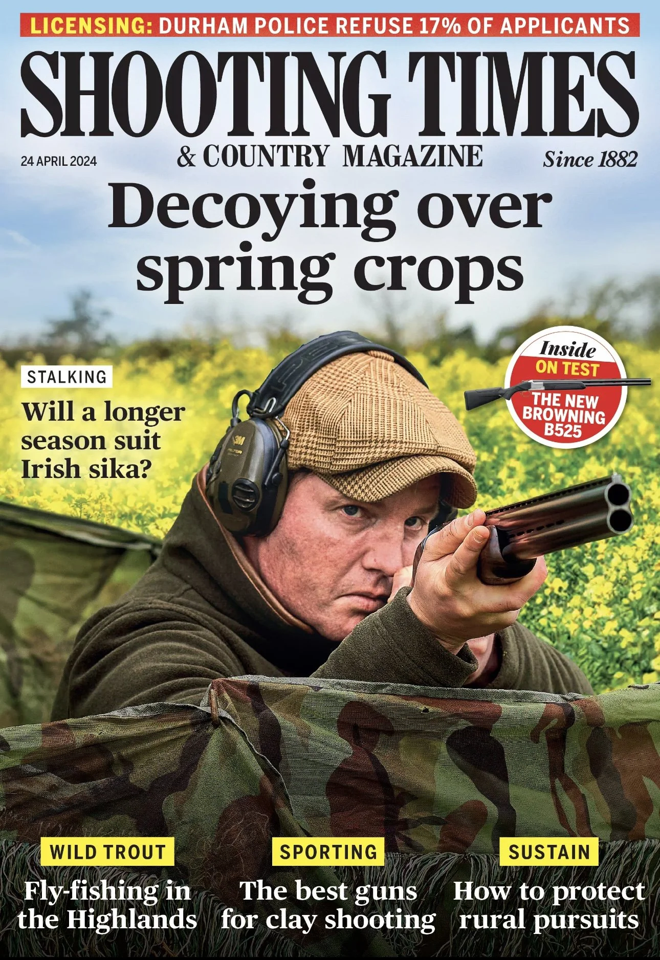 Magazine cover of Shooting Times & Country Magazine, dated April 24, 2024. The cover features a man aiming a shotgun, wearing headphones and a cap, in a field of yellow flowers. Headlines include topics on hunting and rural pursuits, with a main stor