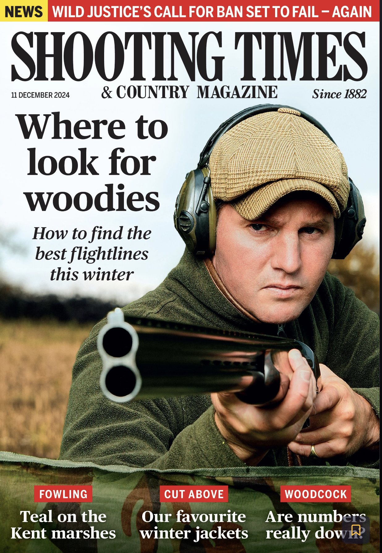 A man in a brown cap and green jacket aiming a shotgun, with headphones on, on the cover of Shooting Times magazine, December 11, 2024, featuring articles on hunting and shooting sports.