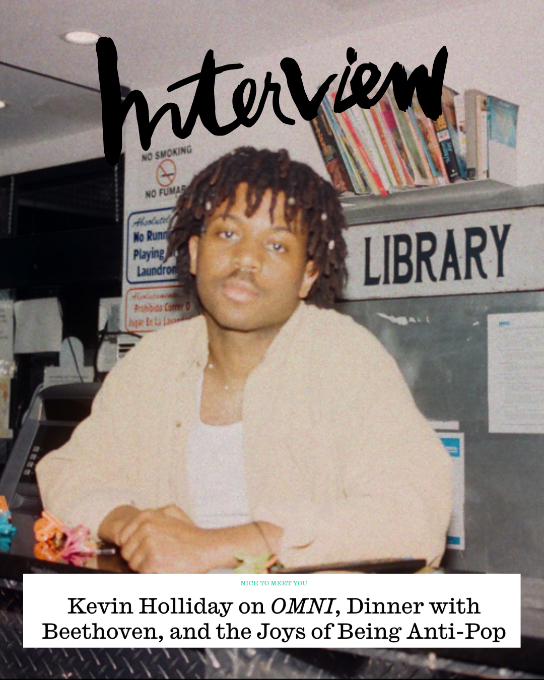 A magazine cover featuring a young man with dreadlocks sitting at a table in a library. Text on the cover reads: 'interview' at the top and 'Kevin Holliday on OMNI, Dinner with Beethoven, and the Joys of Being Anti-Pop' at the bottom.