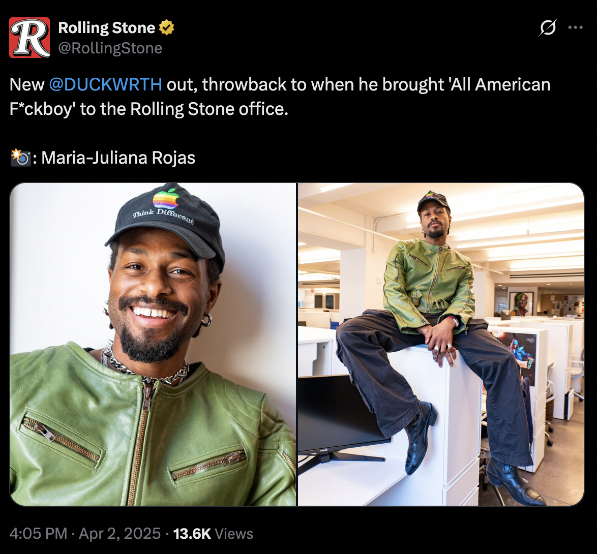 A man with a beard and earrings wearing a black cap with a rainbow Apple logo and the slogan 'Think Different,' a green leather jacket, and a chain necklace smiling for a selfie on the left, and sitting on a desk in the office wearing the same green jacket, black pants, and a cap, with a modern office background on the right.