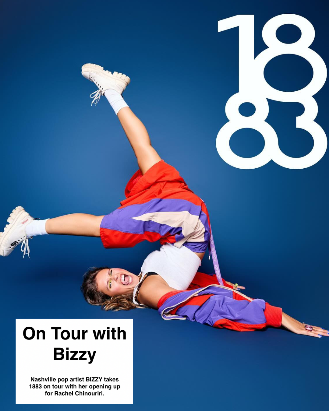 A woman dressed in colorful athletic clothing poses playfully on a blue background, with the large white numbers '1883' in the top right corner. She is lying on her side with one leg raised and bent, smiling at the camera. The text box in the bottom left corner reads: 'On Tour with Bizzy. Nashville pop artist BIZZY takes 1883 on tour with her opening up for Rachel Chinouriri.'