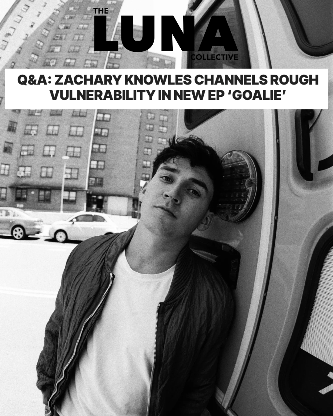 Black and white photo of a young man leaning against an ambulance, with city buildings and cars in the background. Text overlay reads 'The Luna Collective' and 'Q&A: Zachary Knowles Channels Rough Vulnerability in New EP 'Goalie'.
