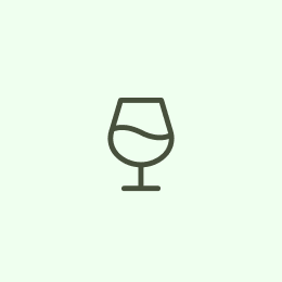 An icon of a wine glass with liquid inside.
