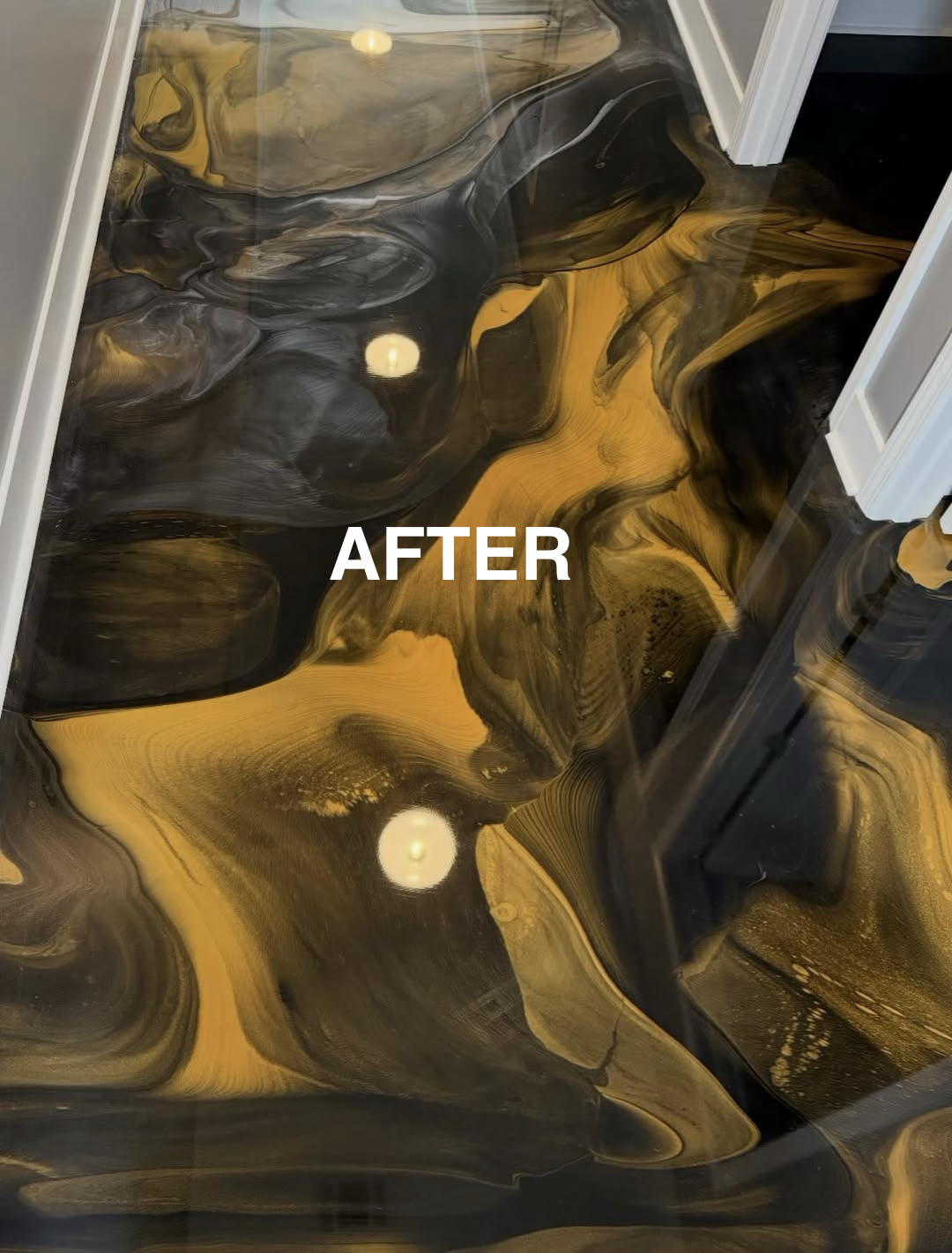 A glossy floor with swirling black and gold patterns, with the word 'AFTER' written on it.