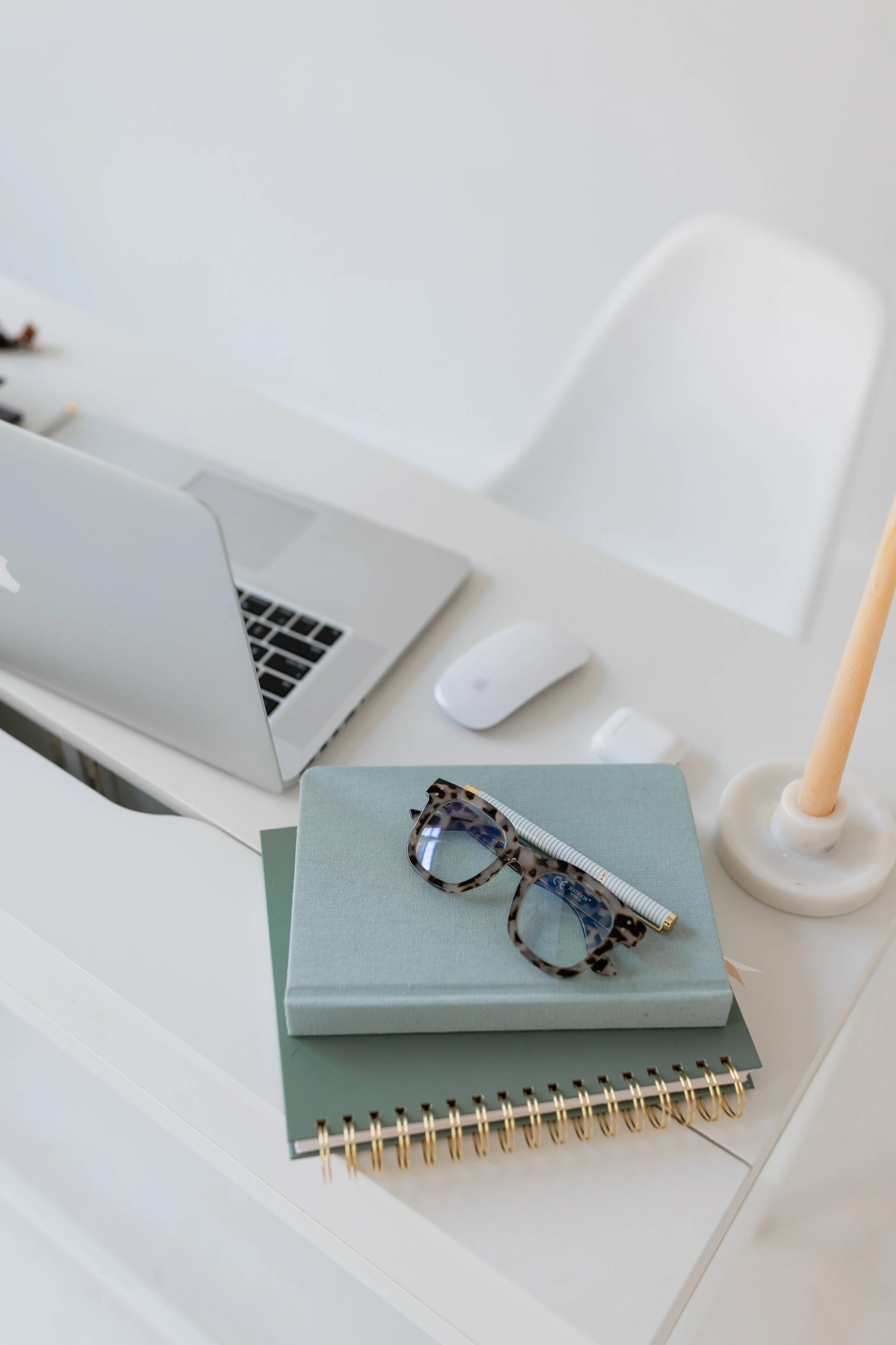 Soft, natural-light image of a notebook and pen on a desk, suggesting reflection and unhurried decision-making.