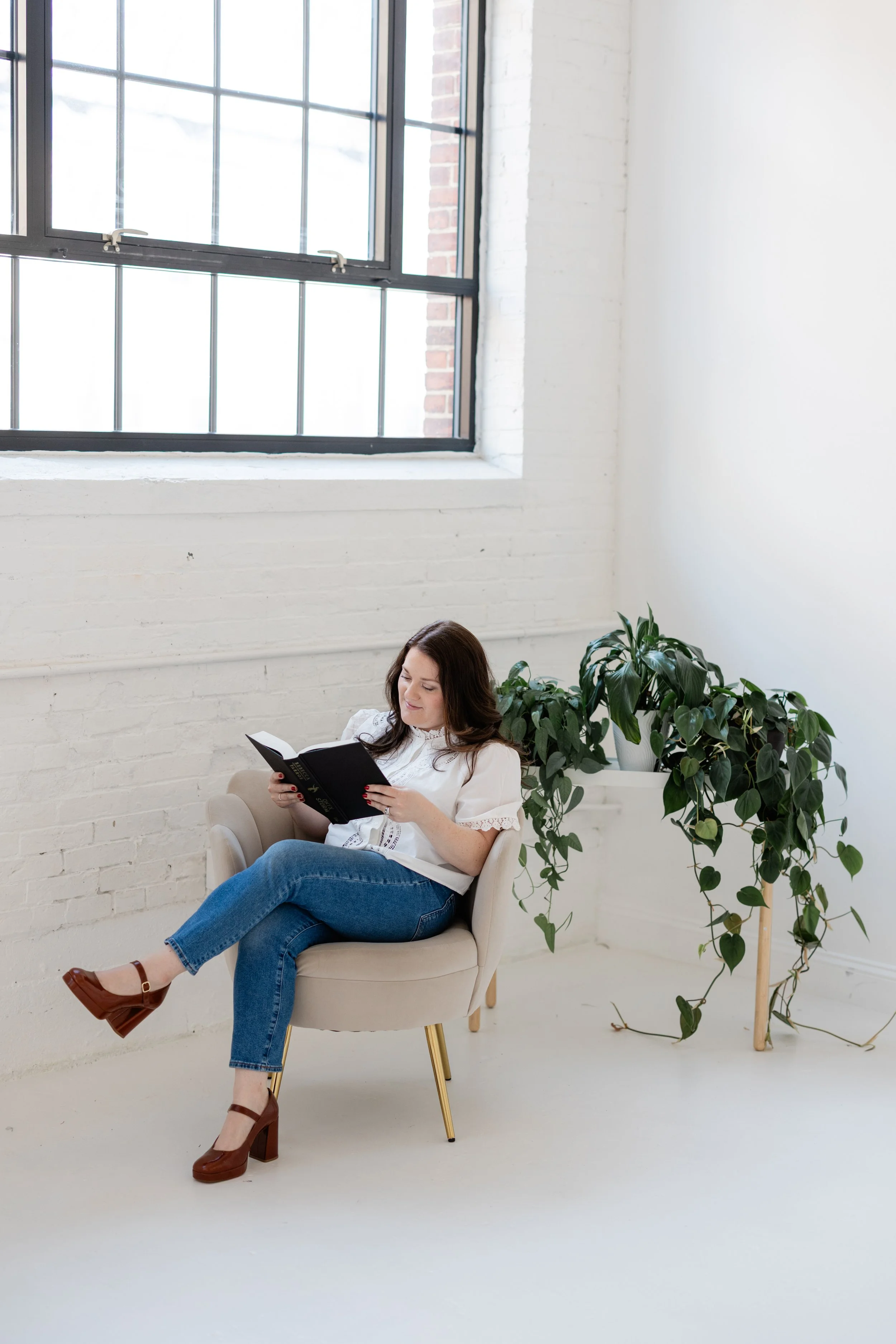 Briana Wells in a thoughtful moment, emphasizing reflective advisory work.