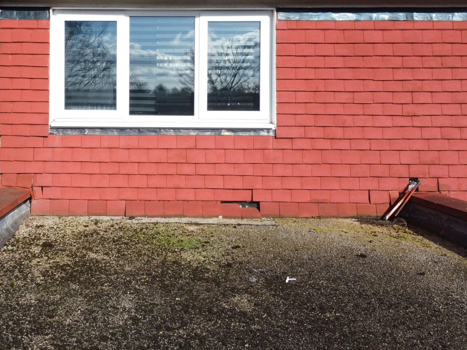 Displaced roof tiles above extension flat roof SE London