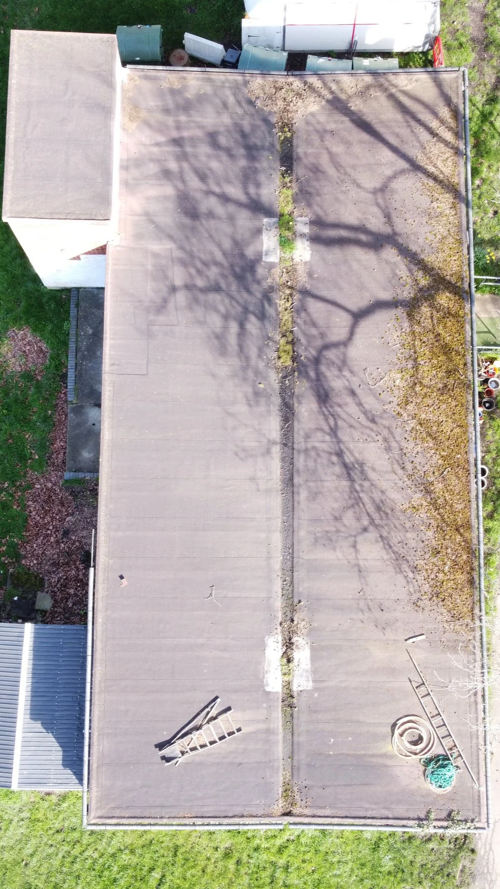 Aerial top view of a rectangular butterfly roof in Croydon showing the central valley drainage channel.