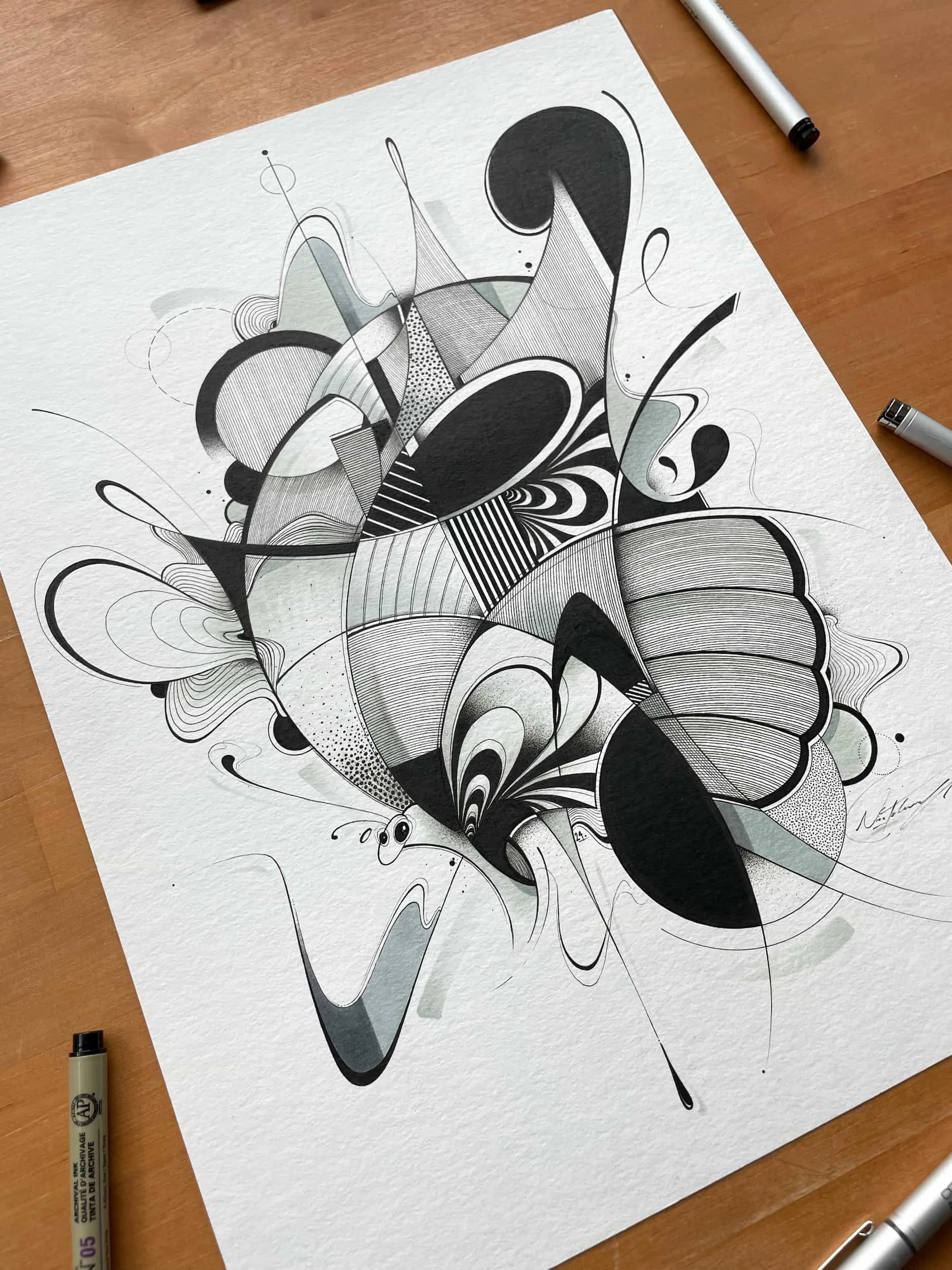 Abstract black and white geometric drawing on textured paper with various shapes and lines.