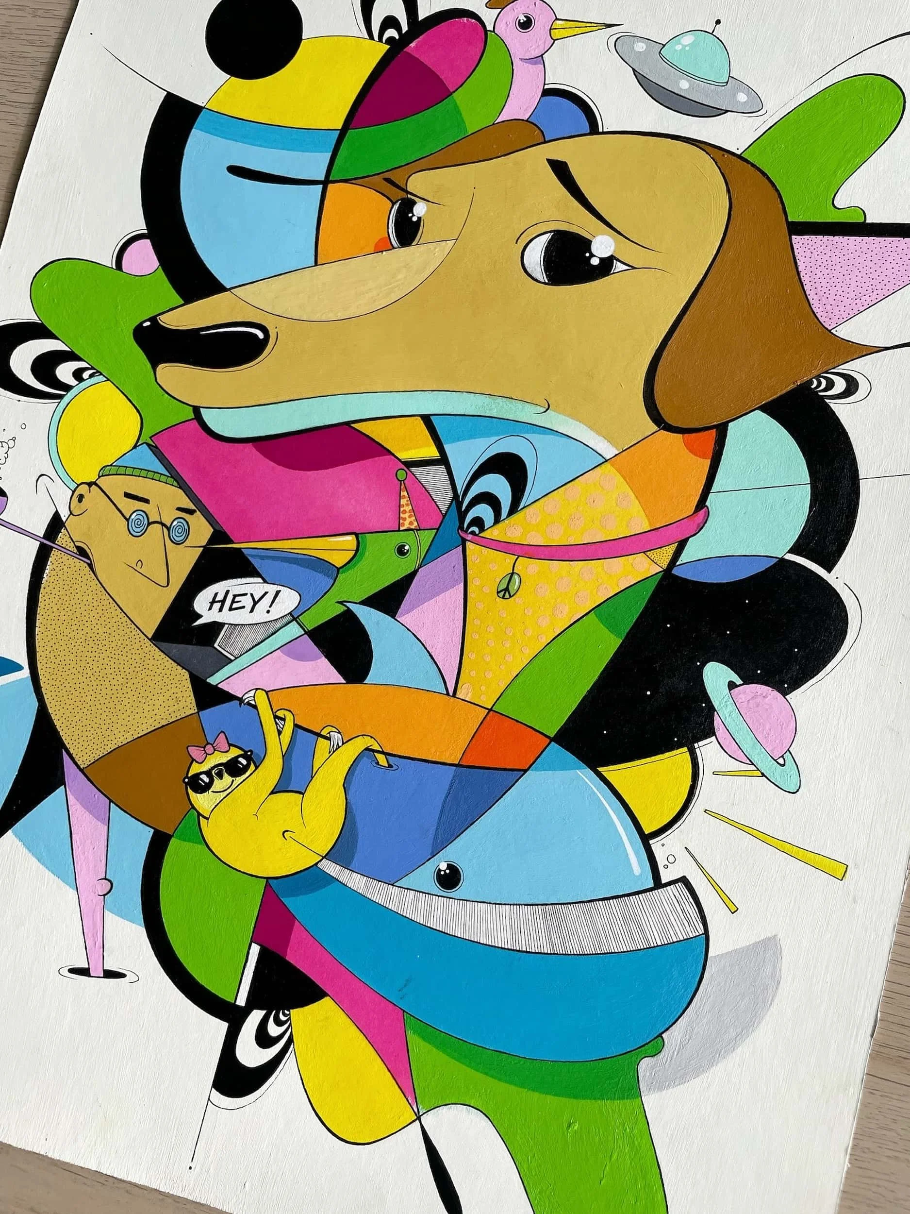 Colorful abstract artwork featuring a dog's face with expressive eyes, surrounded by whimsical characters and shapes, including a yellow sloth with sunglasses holding a swinging ring, planets, and stars.