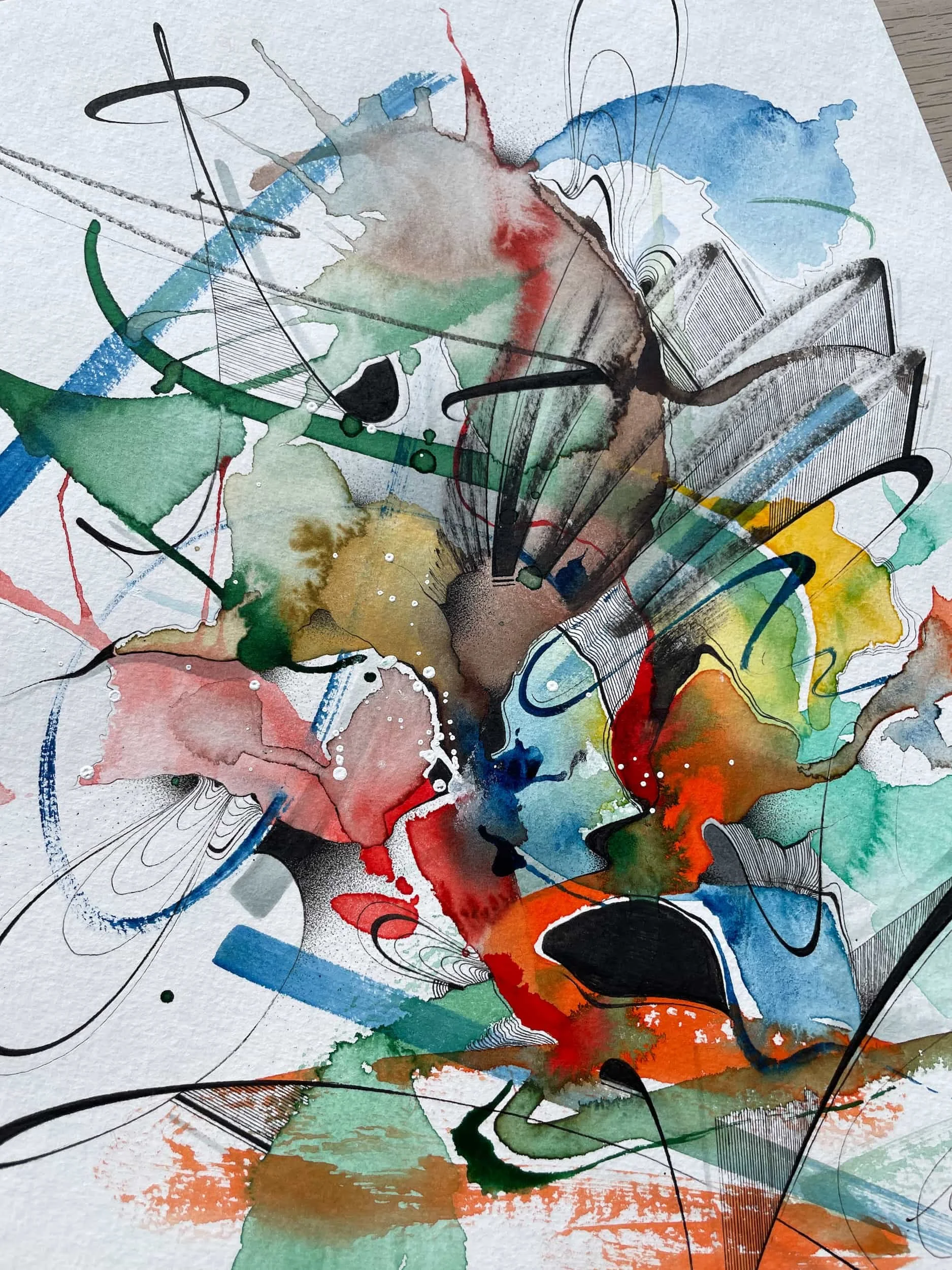 Abstract watercolor painting with splashes of red, green, blue, yellow, black, and brown, with black ink lines and streaks.