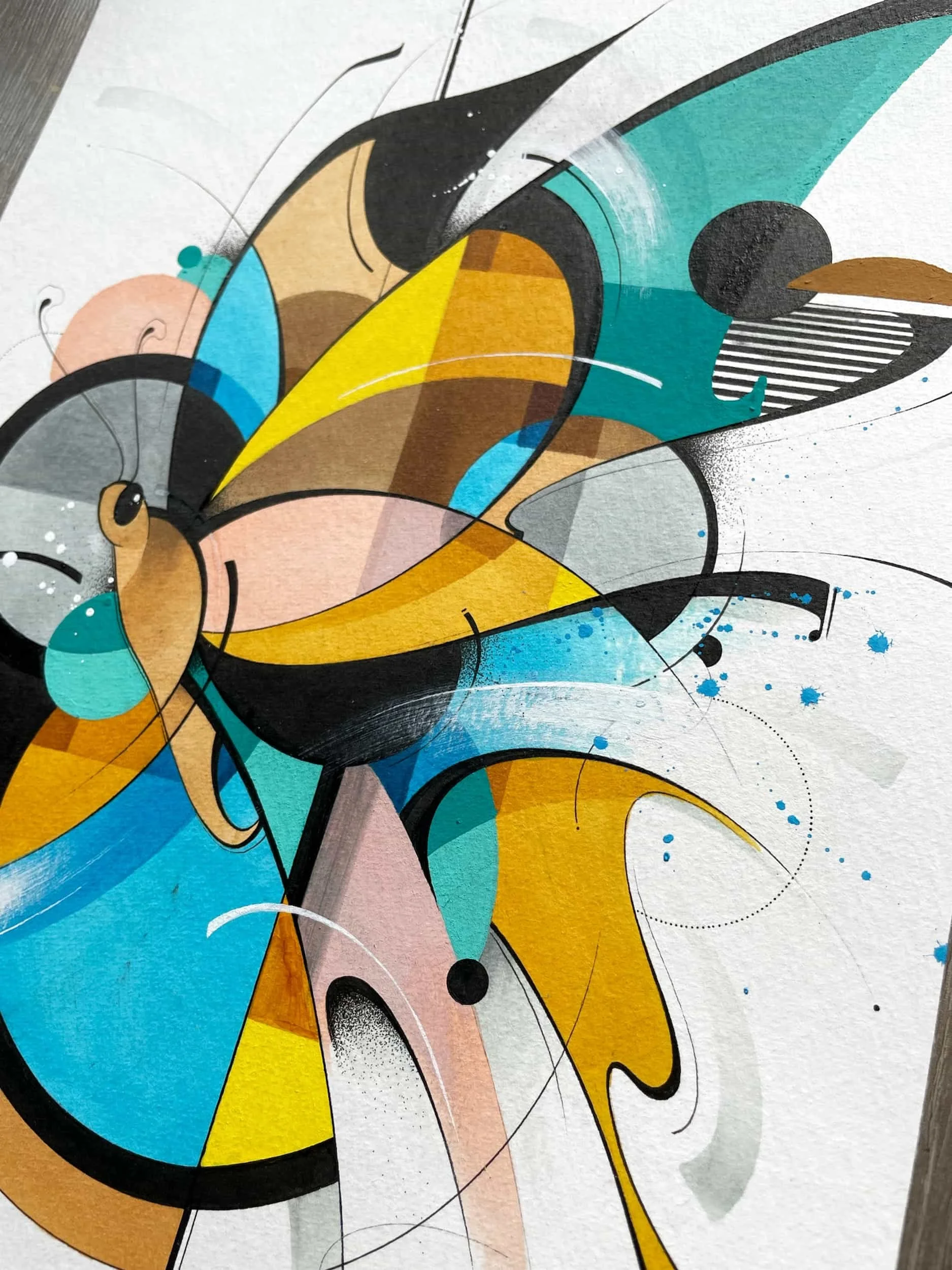 Abstract geometric street art mural featuring colorful shapes in blue, yellow, black, pink, and teal with black outlines and fine detailed lines.