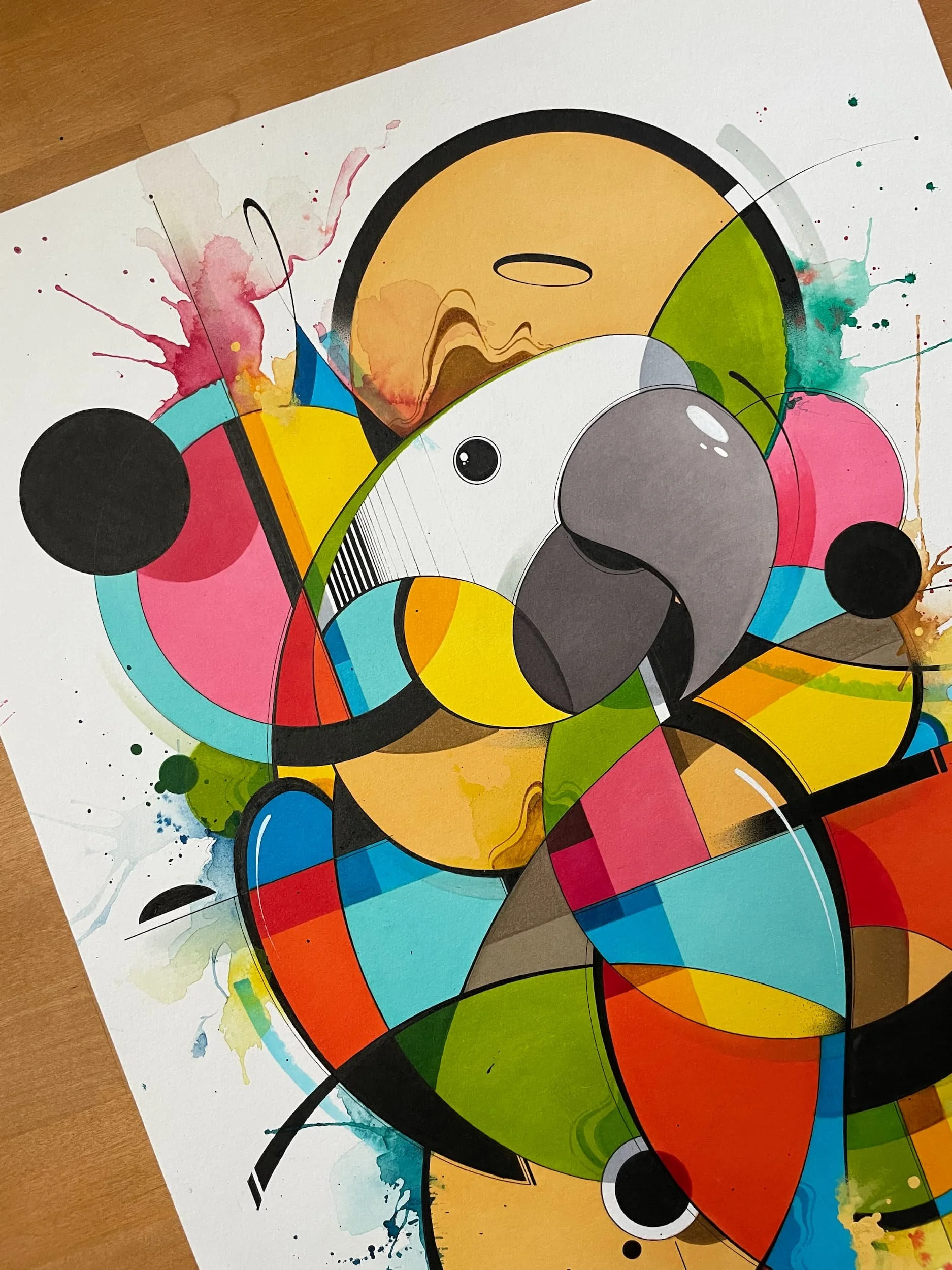 Colorful abstract artwork featuring geometric shapes, splashes of paint, and a stylized parrot with a prominent beak and eye.
