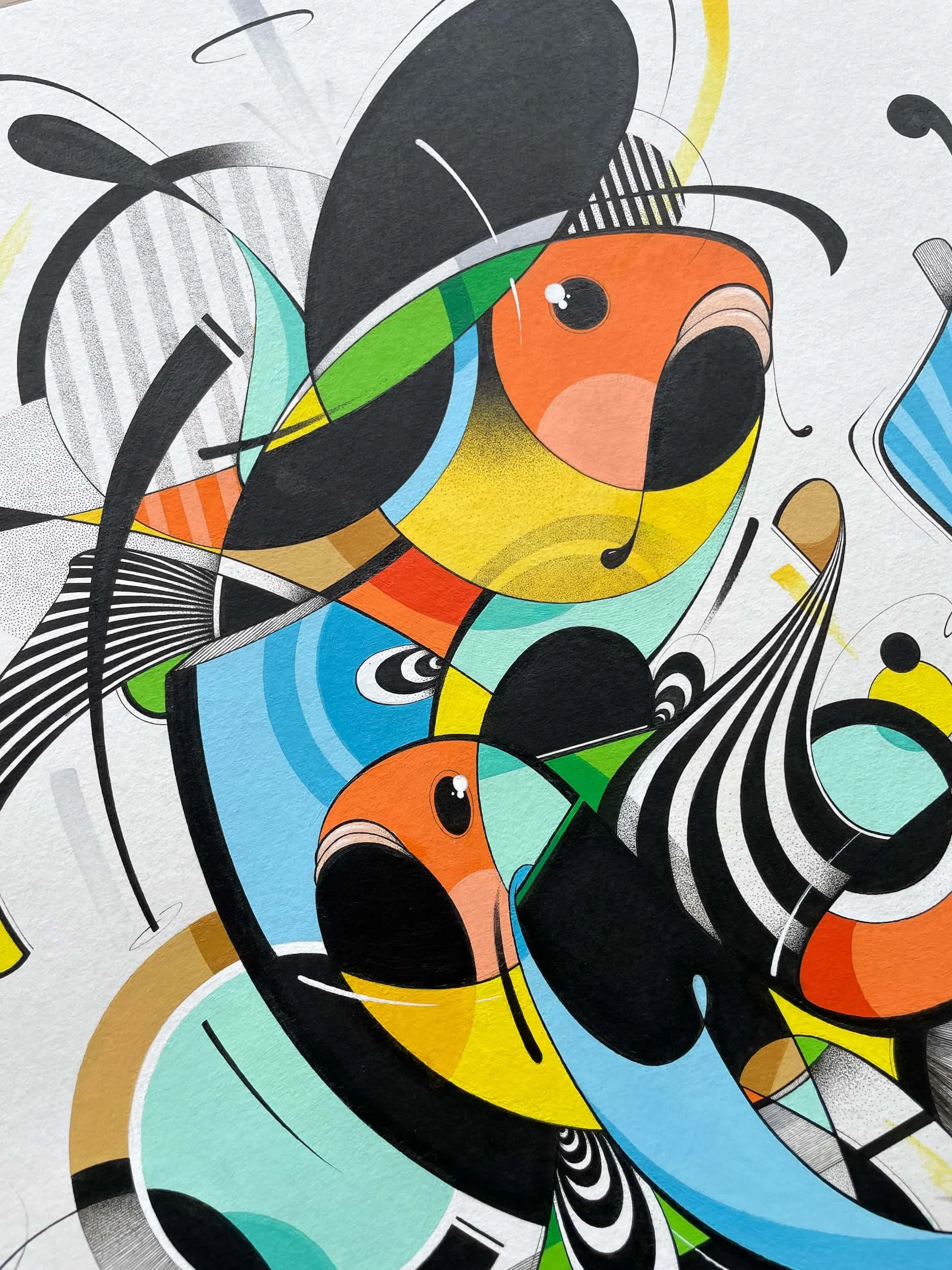 Detail shot of artwork featuring stylized fish with bright colors, black and white patterns, and swirling lines.