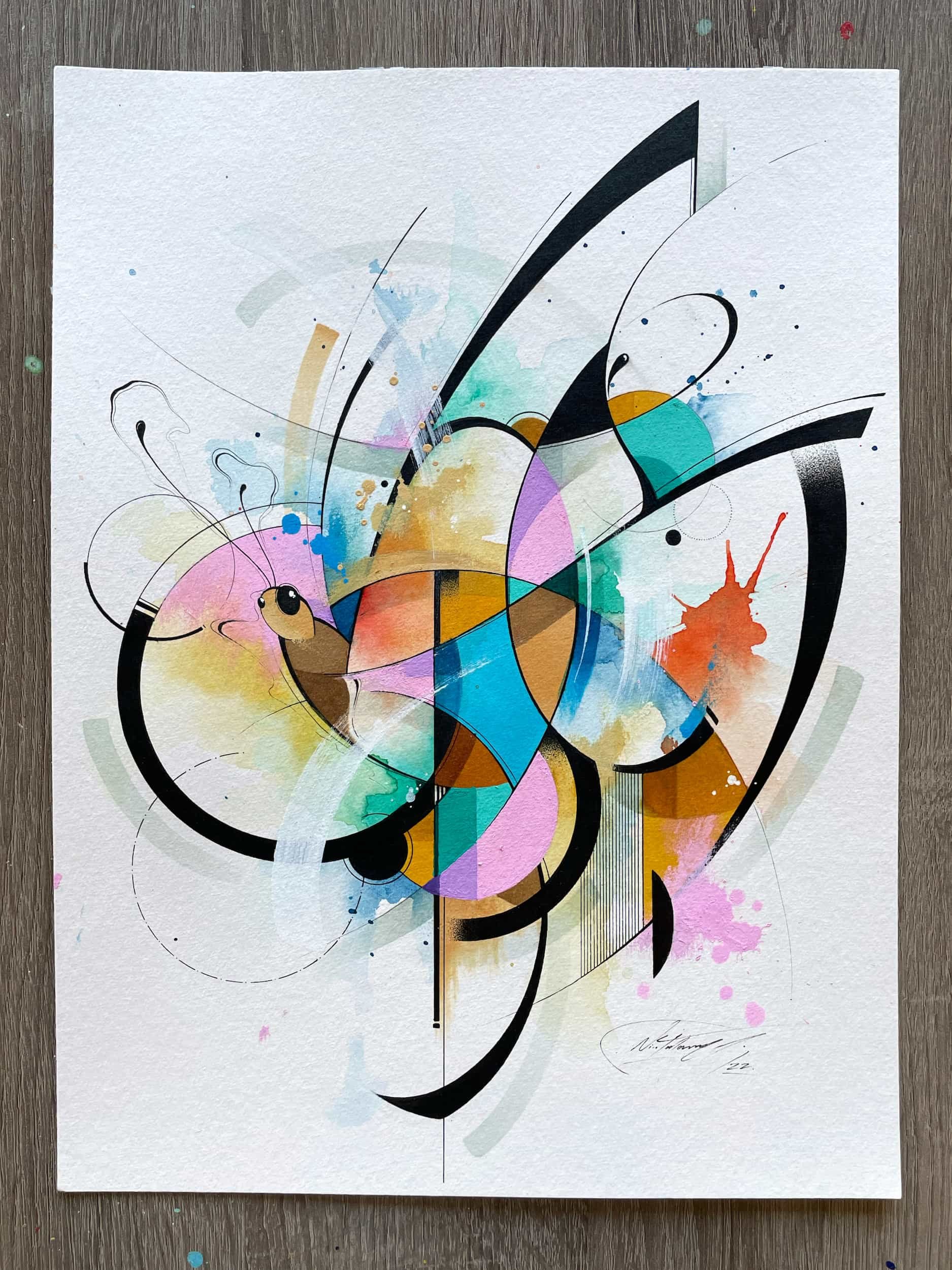 An abstract watercolor painting featuring black curved lines, colorful geometric shapes, and splashes of pink, blue, orange, purple, and green on textured white paper.