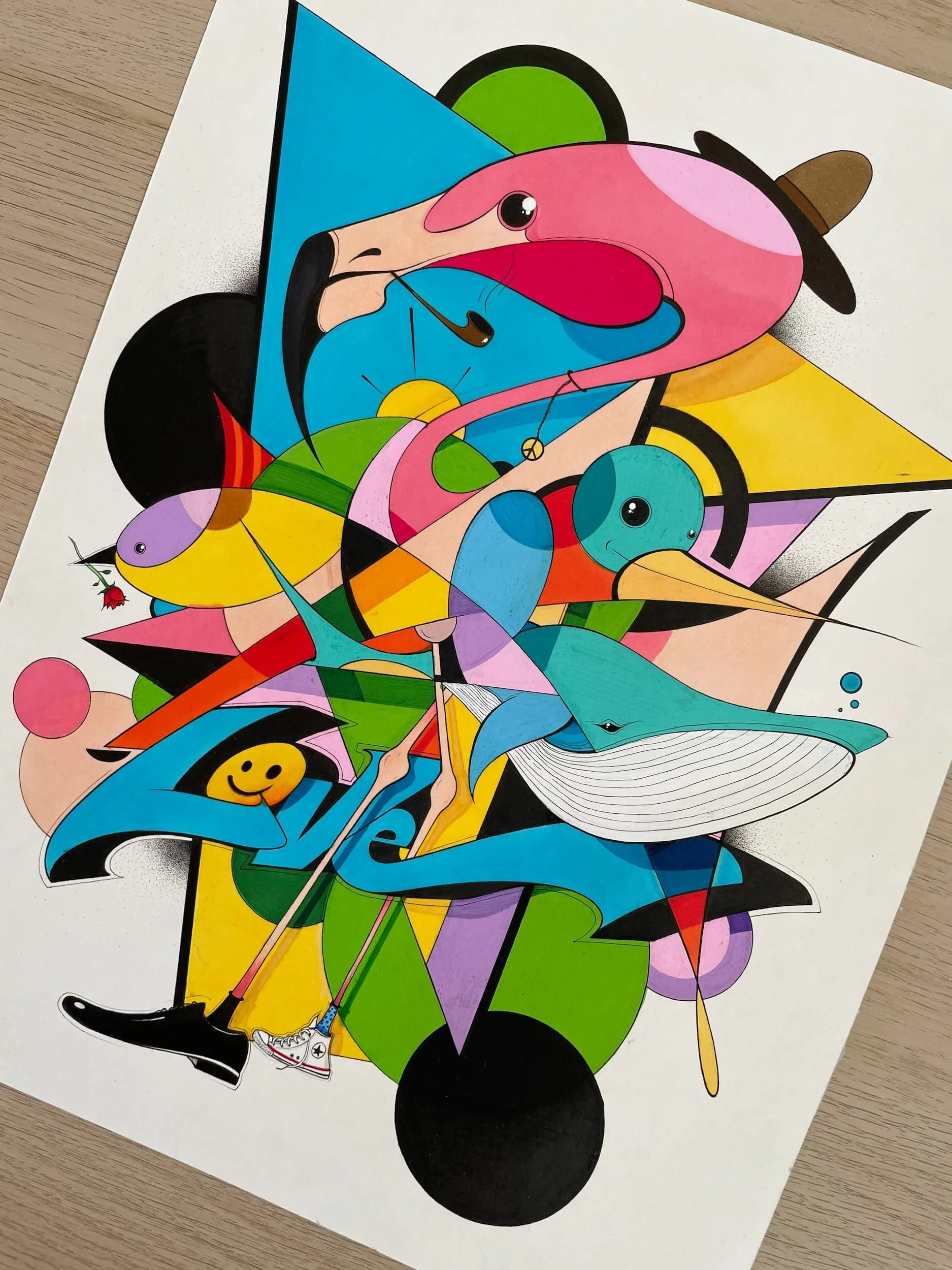 Colorful abstract street art with various shapes, lines, and cartoon-like figures, including a smiley face, a whale, and a ladybug.