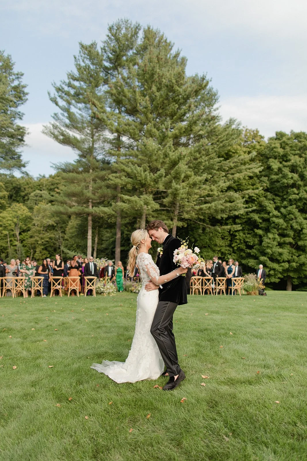 Couple stopping to kiss at floral filled Wedding Ceremony designed by 42 North World | Freda Banks Photography | Mayflower Inn & Spa Auberge