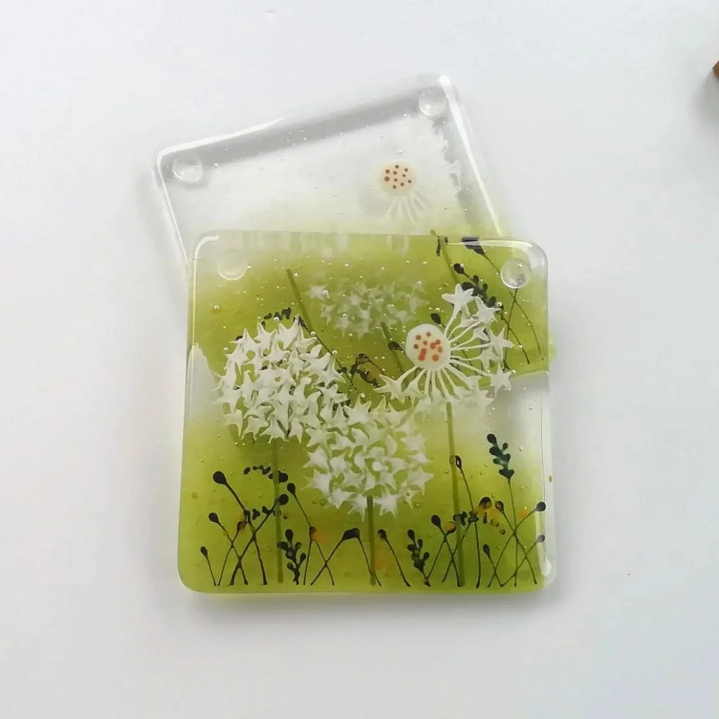 One of my loves are dandelions, I'll add them to my work whenever I can 🤣. These dandelion coasters are in my shop.
#dandelions 
#glasscoasters 
#summerfeels 
#patioware 
#winenights