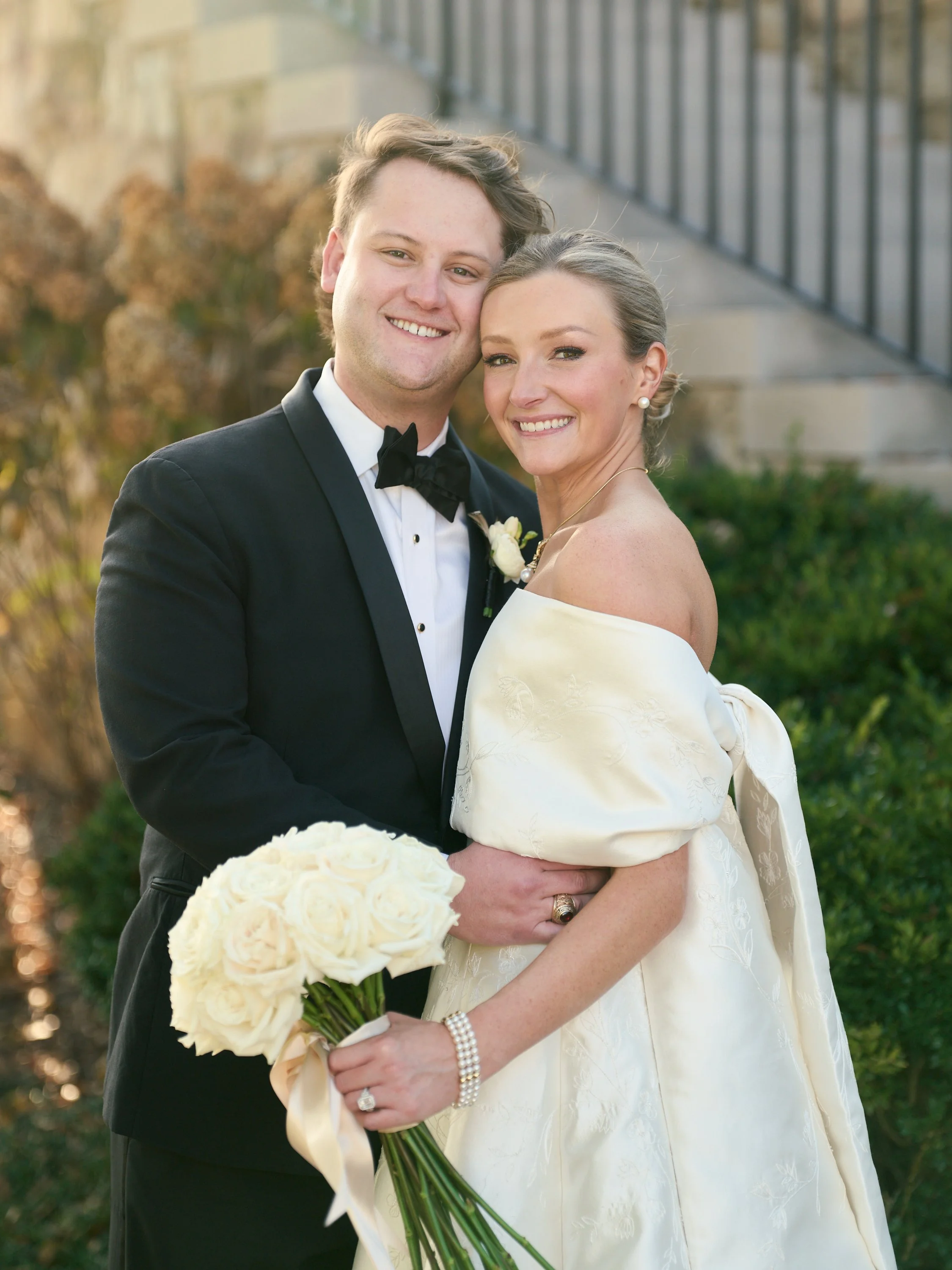 Bride and groom show off a stunning bridal bouquet