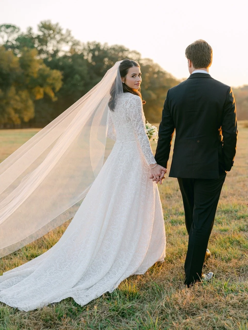 Bride and groom capture the perfect shot during golden hour at a family home