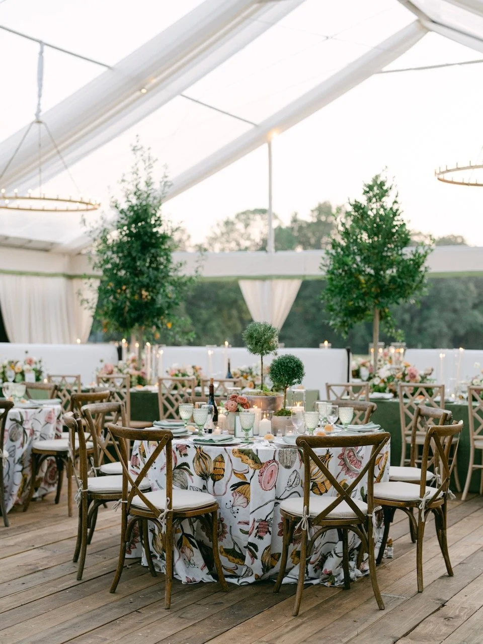 Gorgeous tablescapes take this reception to a new level, under a deluxe clear tent with beautiful chandeliers that match the moment