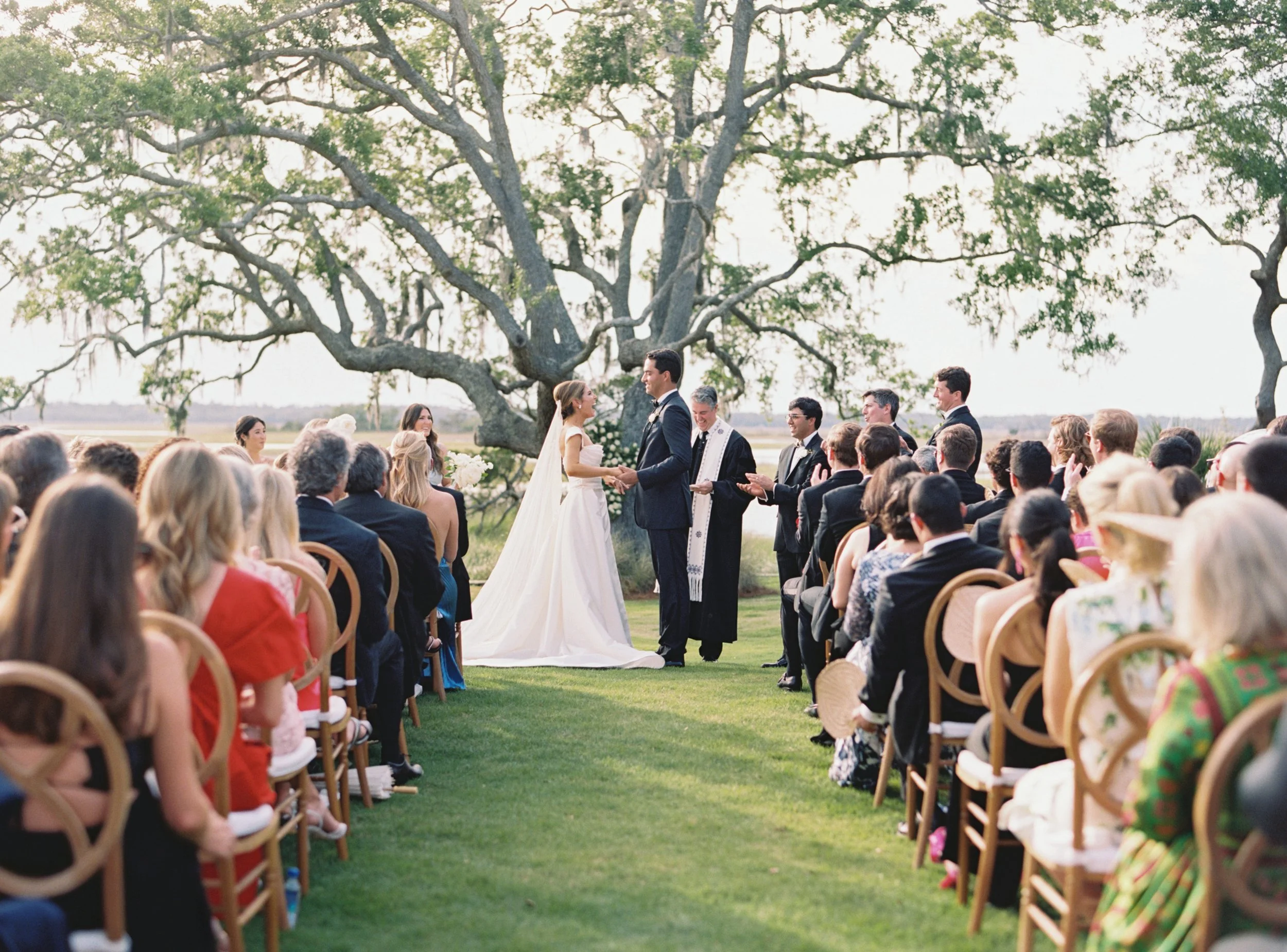 Bride and groom say I Do in front of a gorgeous tree on Sea Island