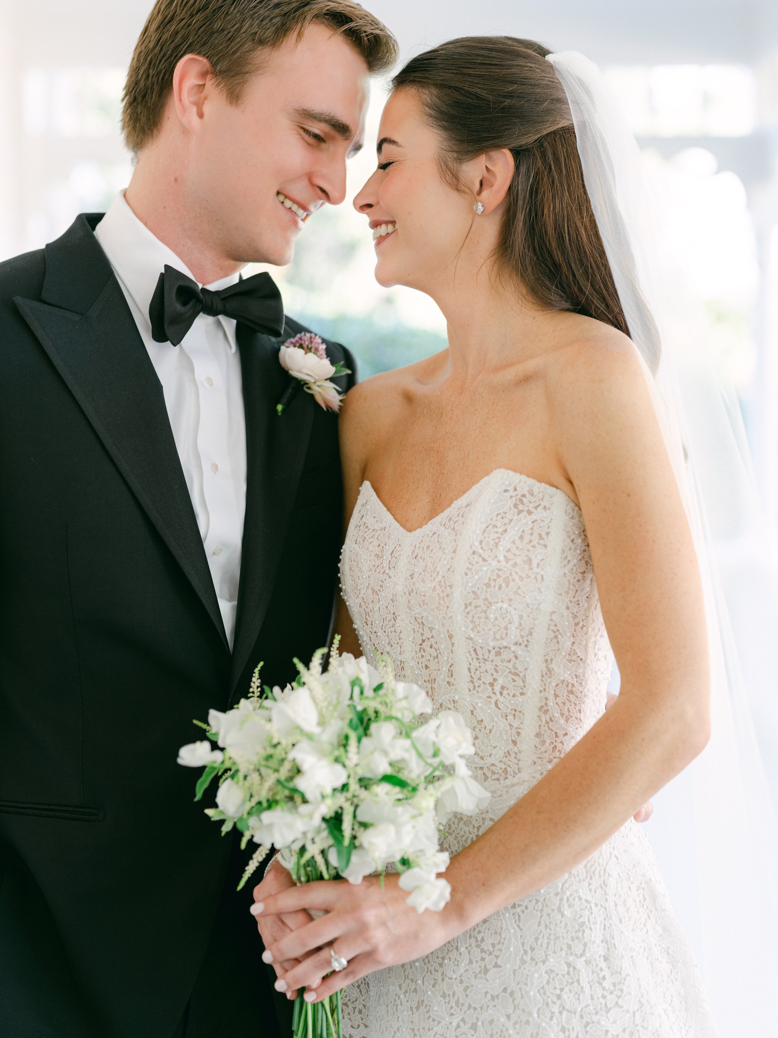 Bride and groom show off a beautiful bridal bouquet