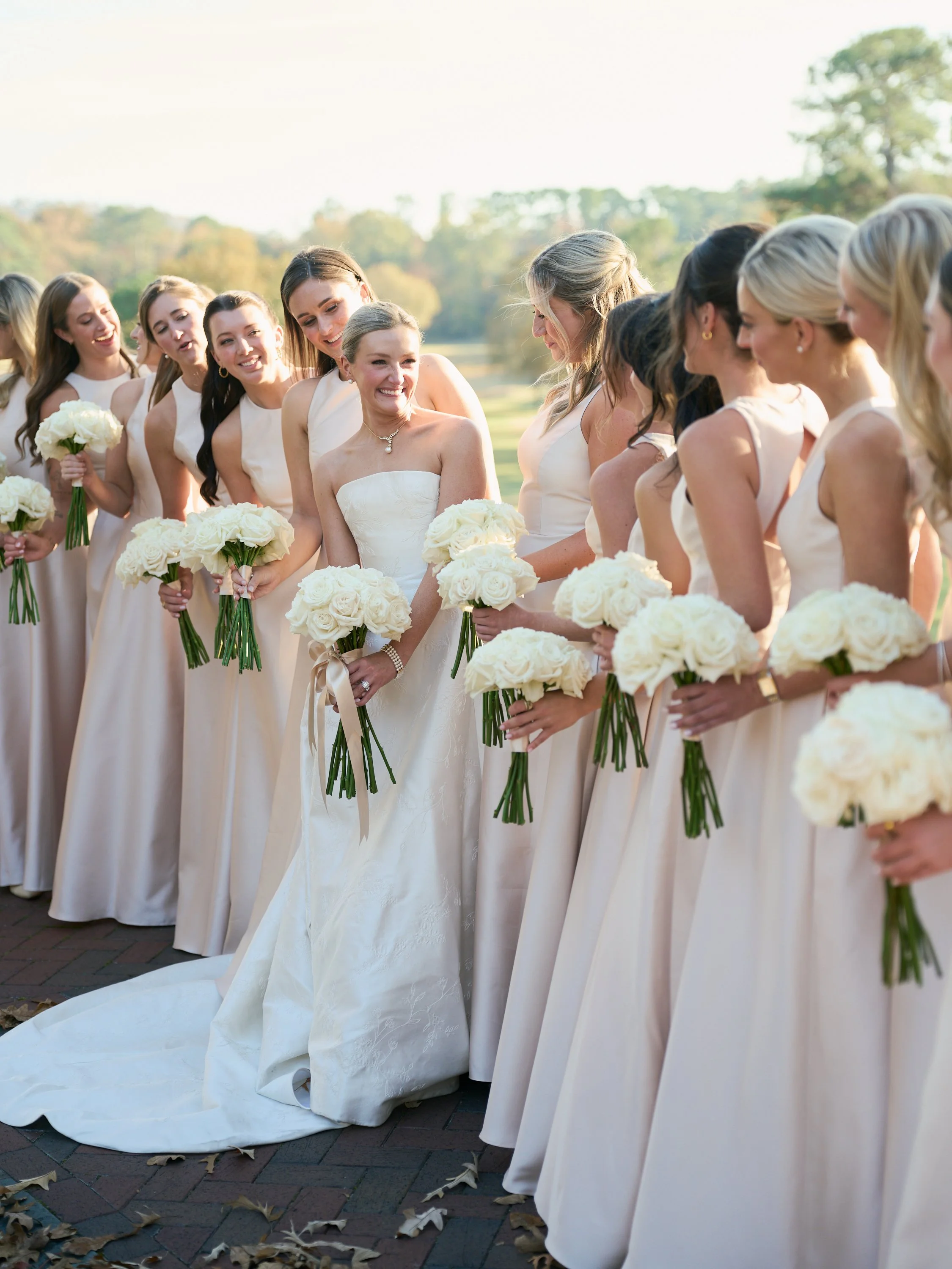 The bridal party shows off stunningly white and full bridal party bouquets 