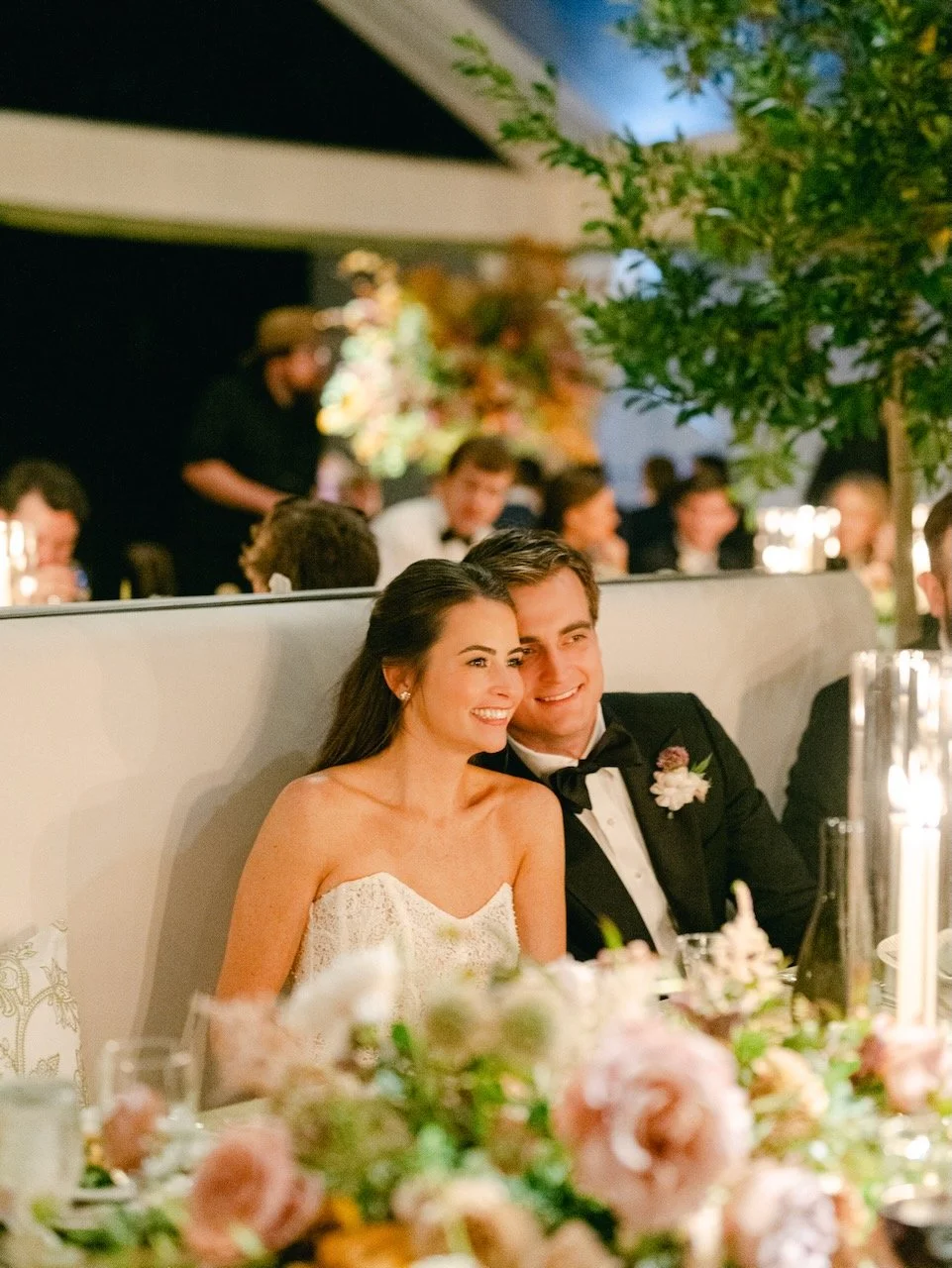 Bride and groom enjoy the evening with beautiful pink and green florals