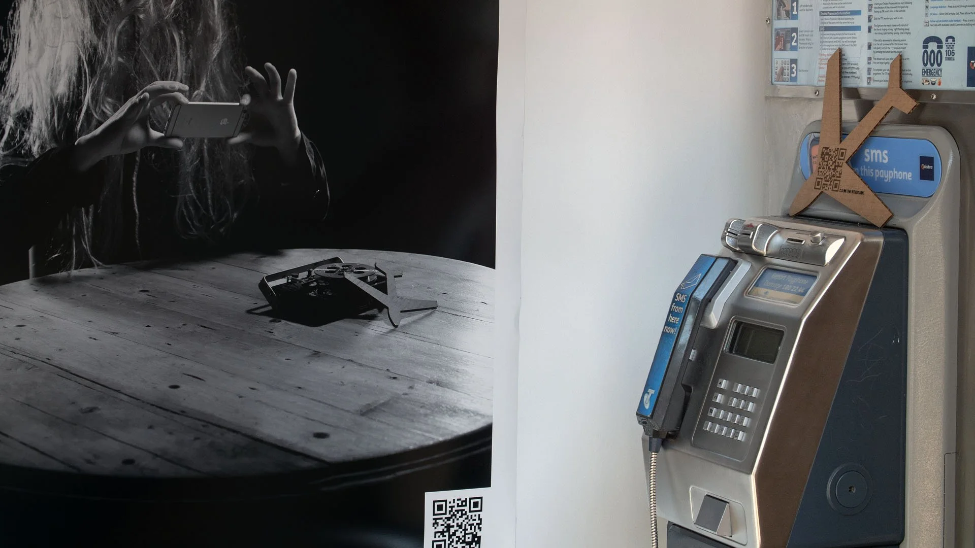 Backyard Psycho (2018)
Manipulated iPhone 6s video | Colour | Stereo Sound |  2' 00" | 23.98 fps |  QR codes embedded in two photographic prints & laser-cut cardboard  | public phone booth