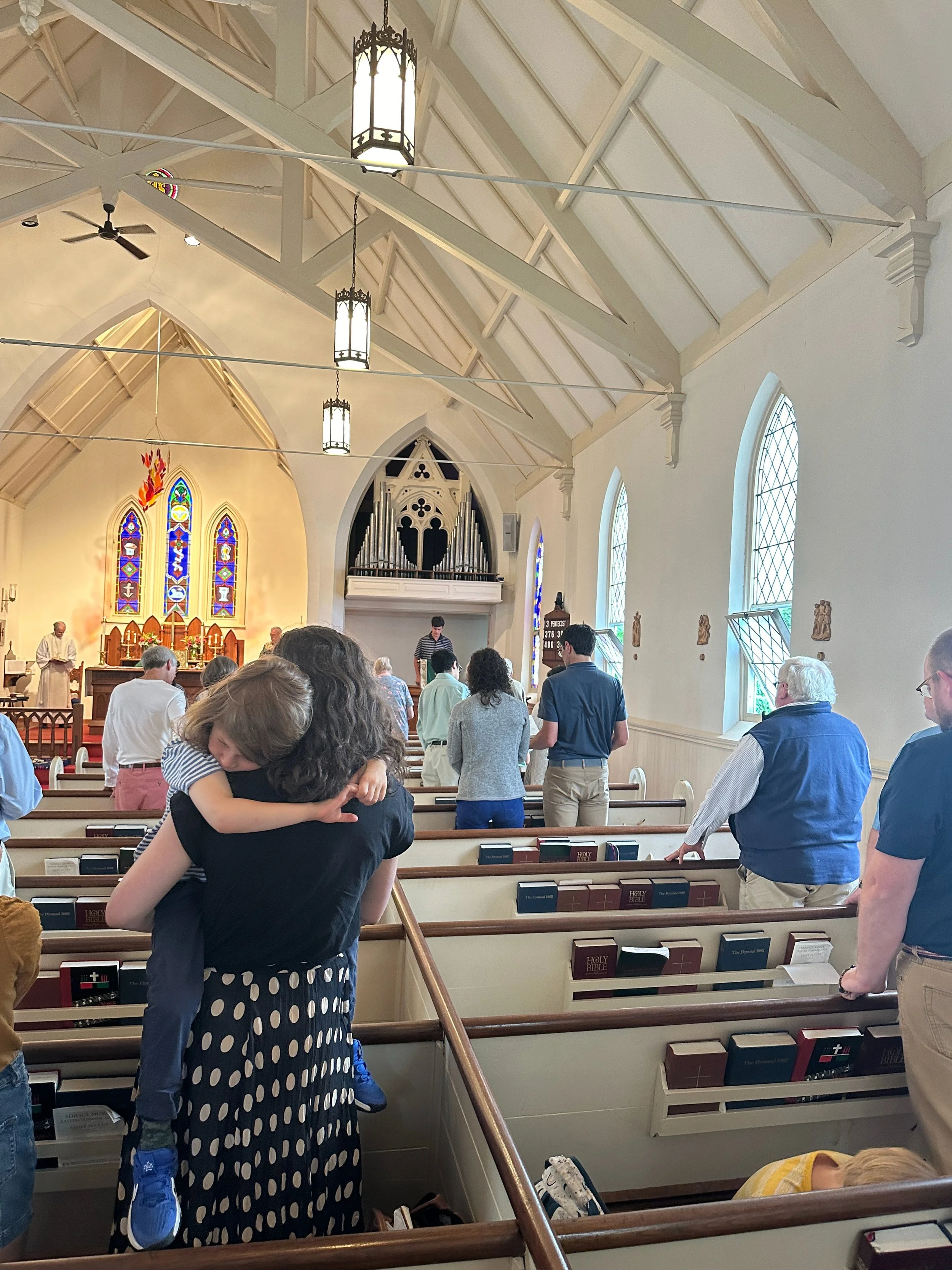 Mother with small child over shoulder during worship