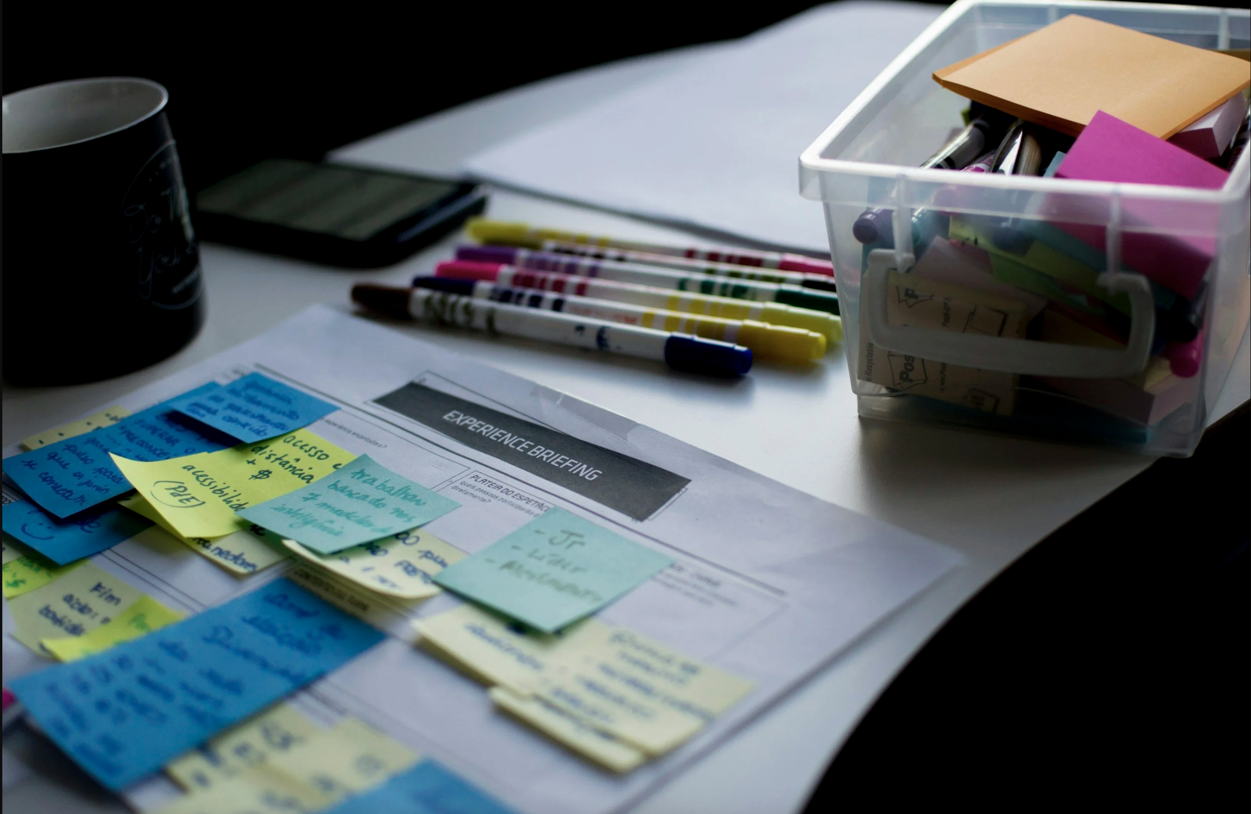 Desk with post-its, markers and a papers