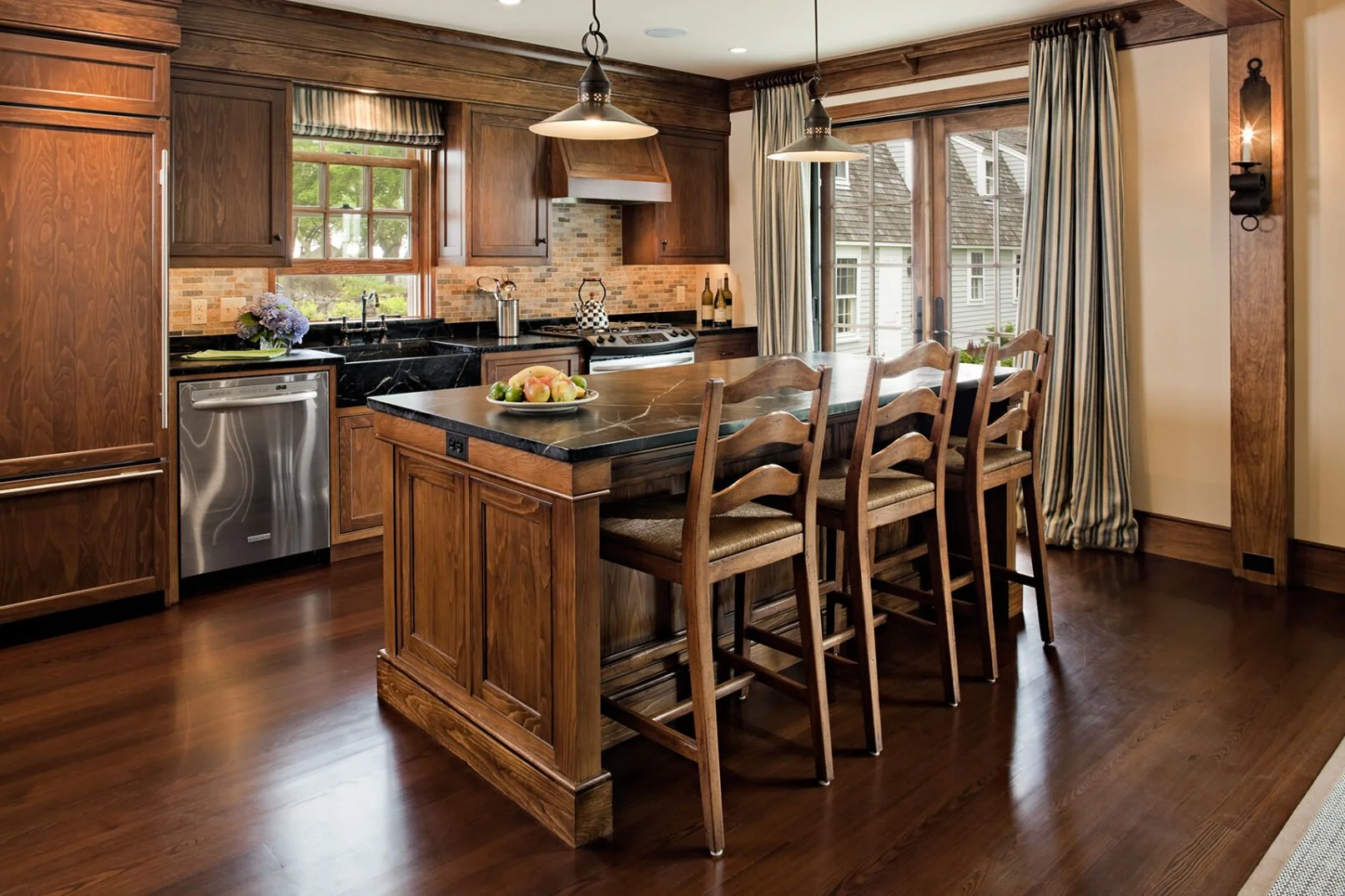 Wooden furniture pieces in a woodworking shop, including a partially painted cabinet, unpainted cabinets, shelving units, and workbenches.