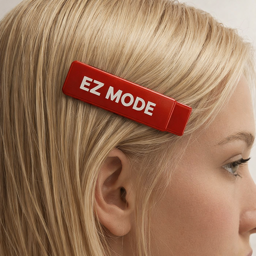 A woman with blonde hair wearing a red hair clip labeled 'EZ MODE'.