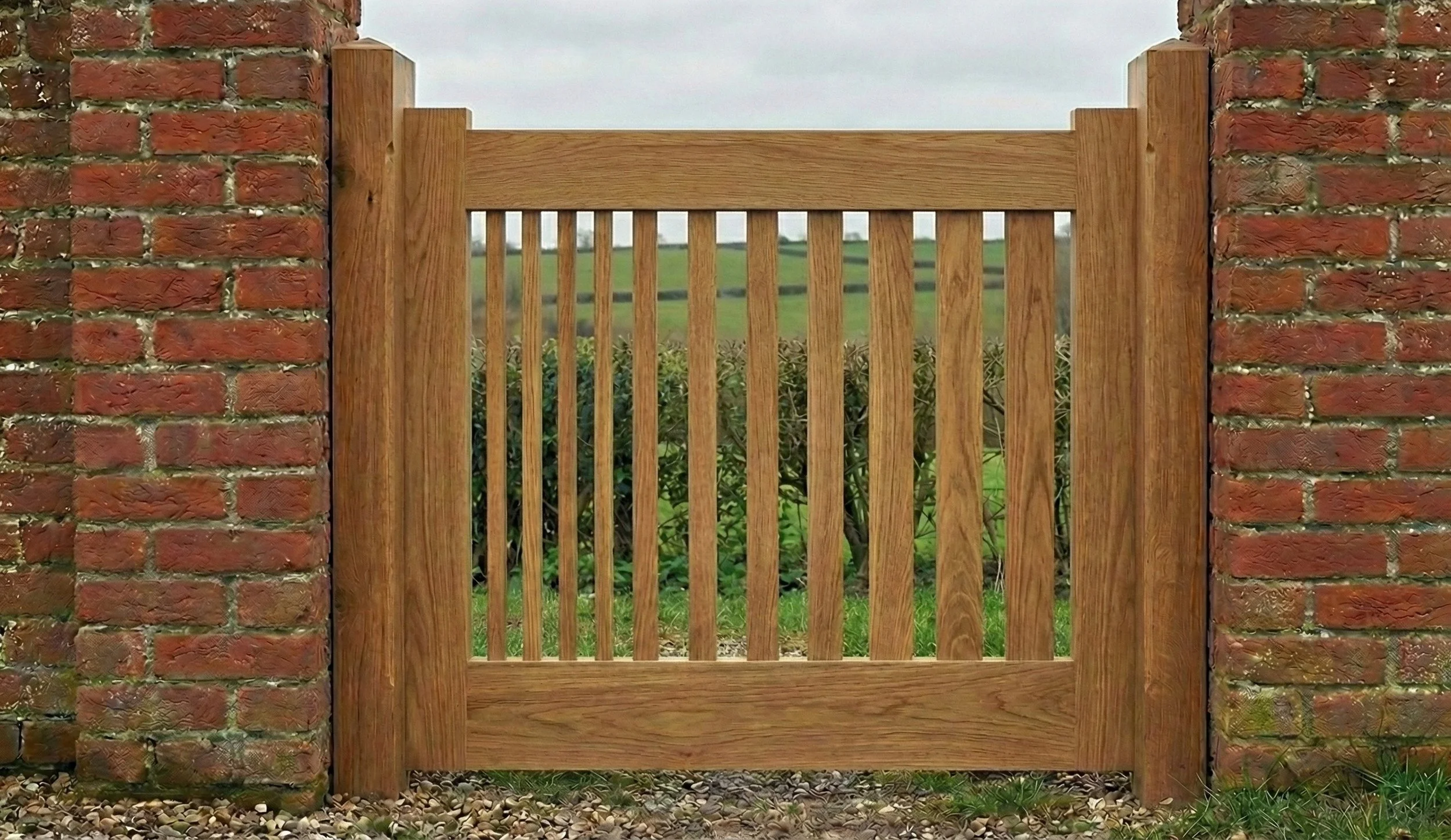 A wooden gate with vertical slats between two brick pillars, overlooking a grassy field with trees in the distance.