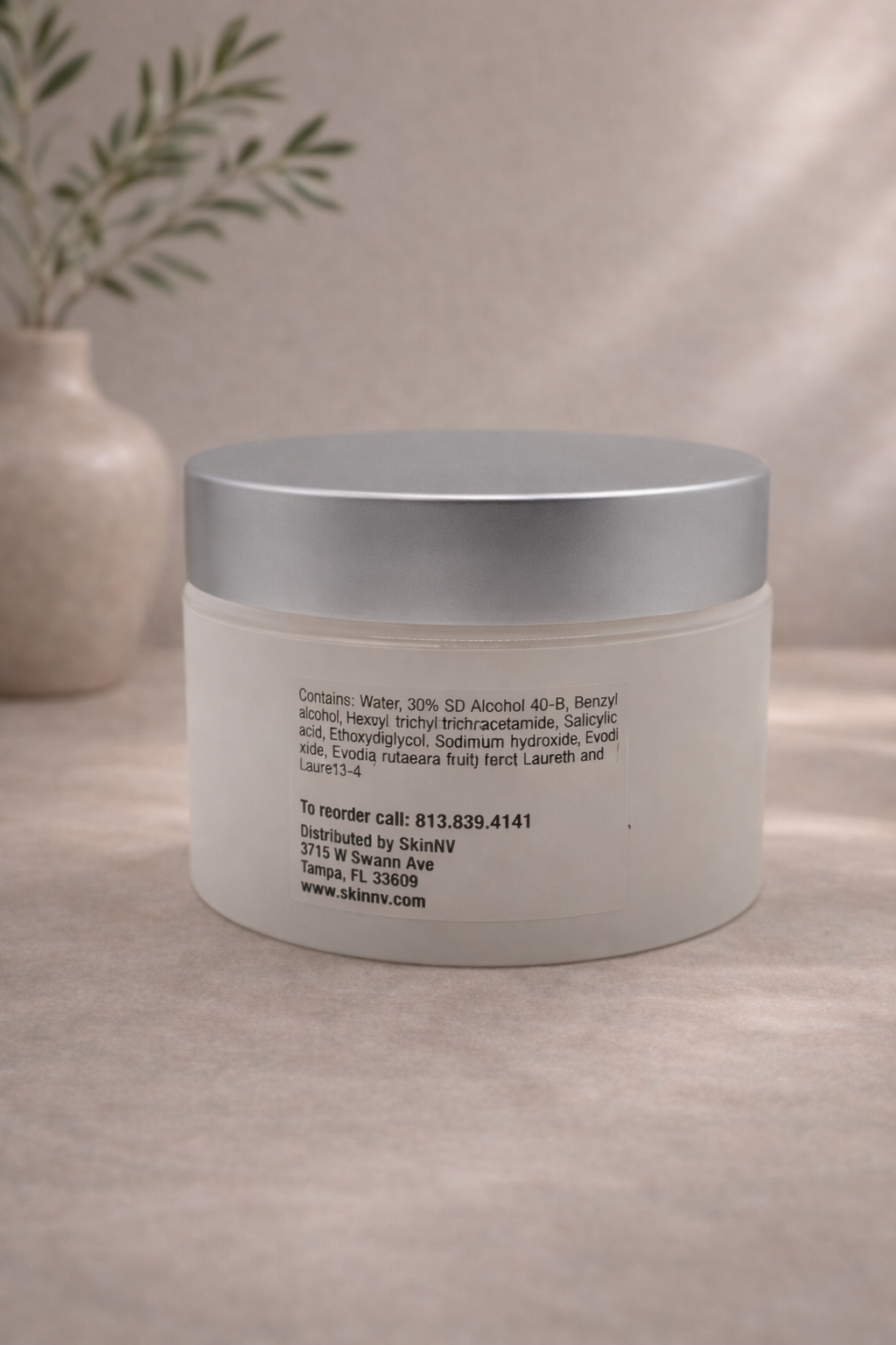 Skincare pad jar and olive branch.png