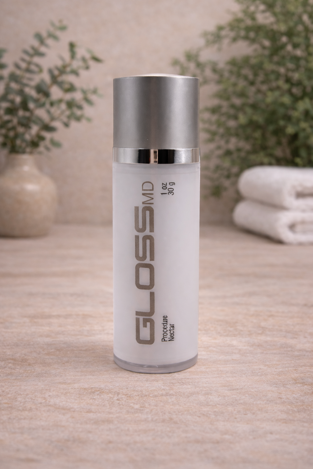 GLOSSMD skincare bottle on stone surface.png